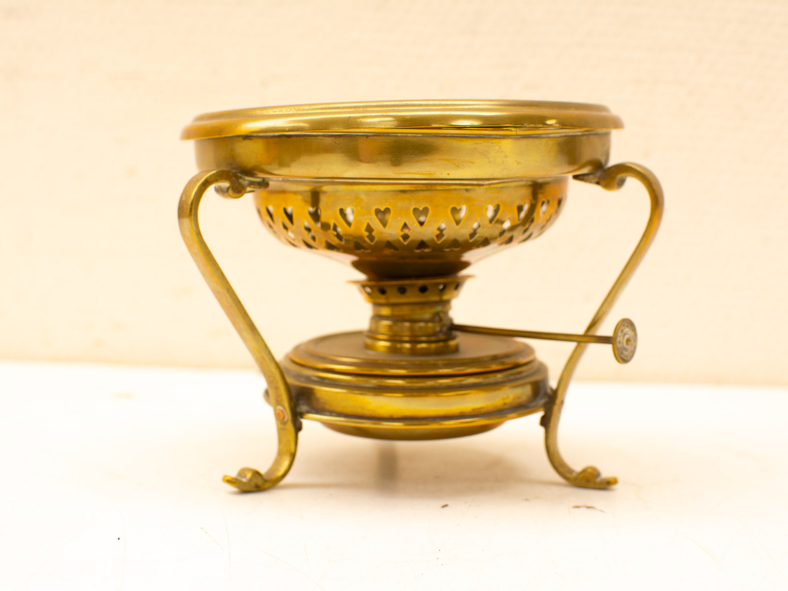 Elegant brass burner with heart-shaped holes, perfect for warming oils and enhancing decor.