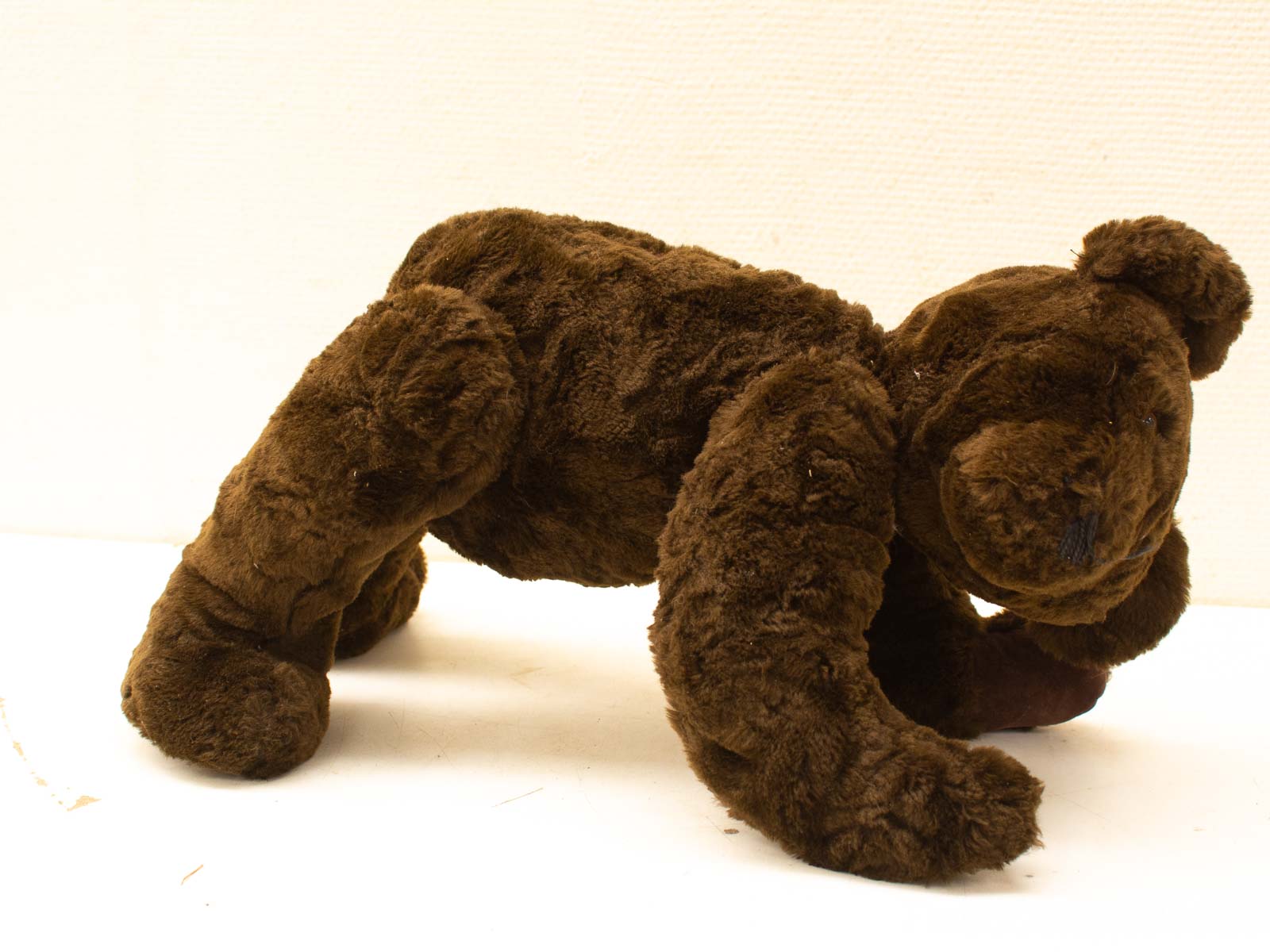 Vintage crawling chocolate brown teddy bear, perfect cuddly companion for kids and nostalgic memories.