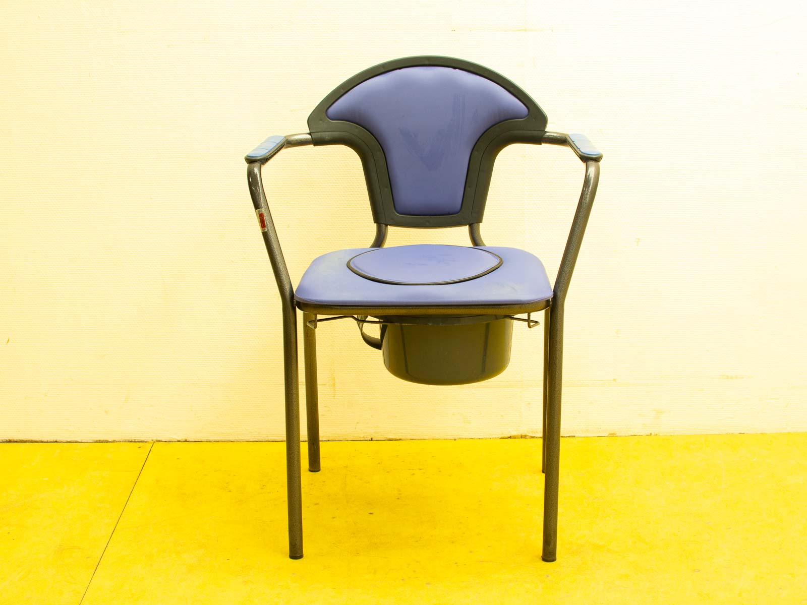 Ergonomic blue chair with metal frame, padded seat, and unique cutout for comfort and stability.