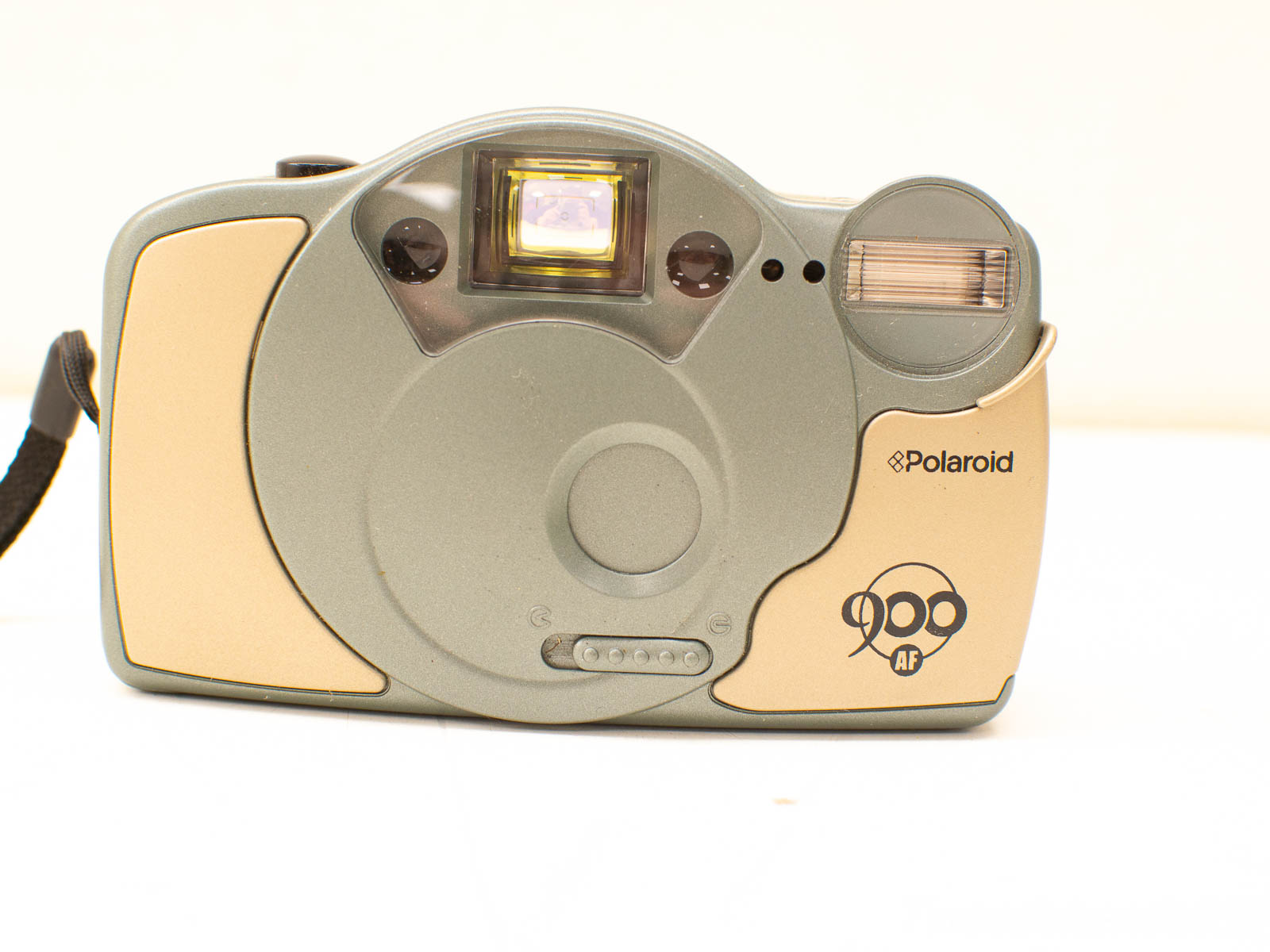 Sleek gray and gold Polaroid camera with autofocus for effortless instant photography.