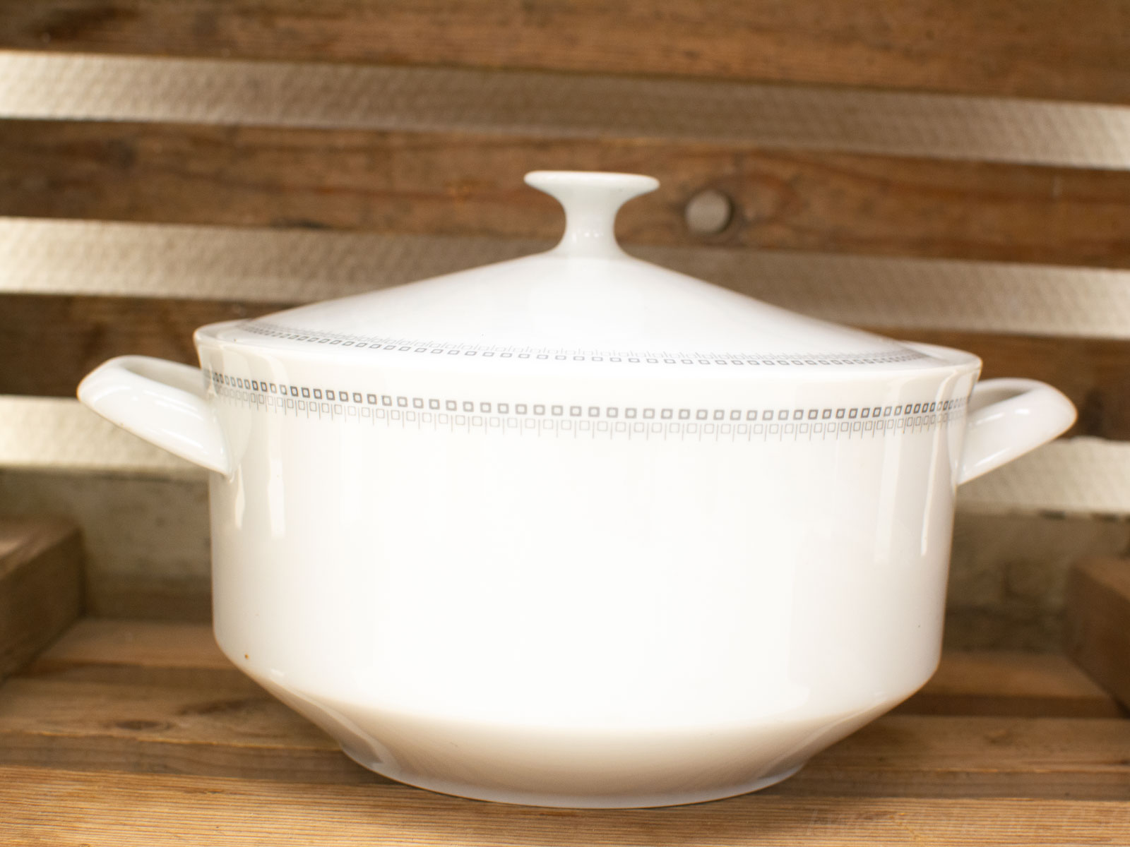 Elegant vintage porcelain casserole dish with lid, ideal for stylish dining and family meals.