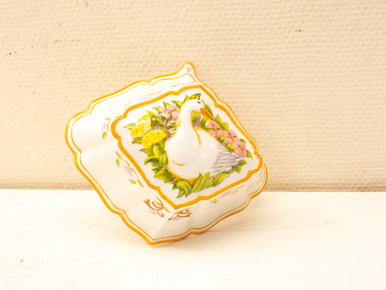 Elegant porcelain dish with a dove and vibrant floral designs, perfect for home decor.