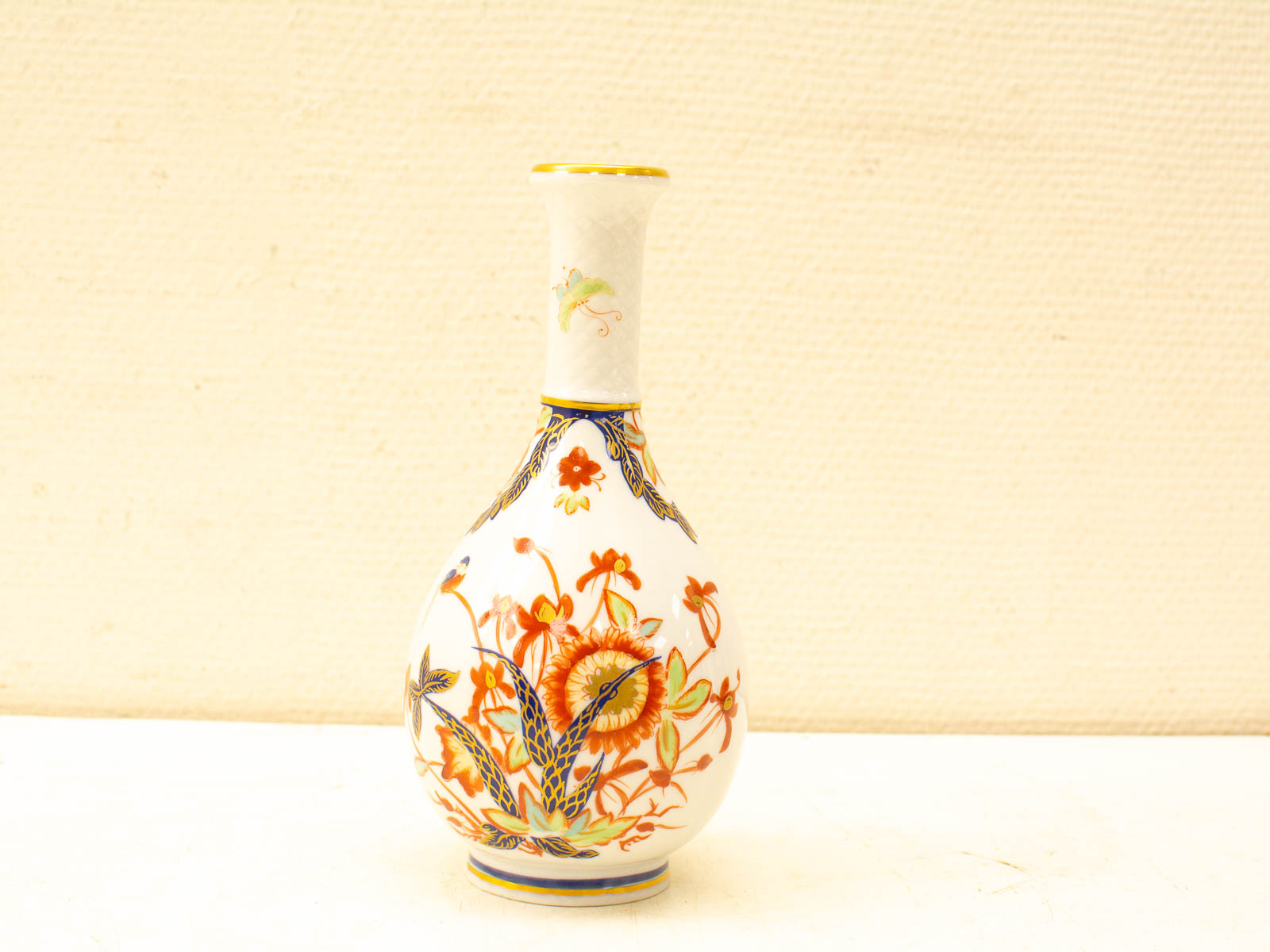 Elegant porcelain vase with vibrant floral patterns and gold accents, perfect for any decor.