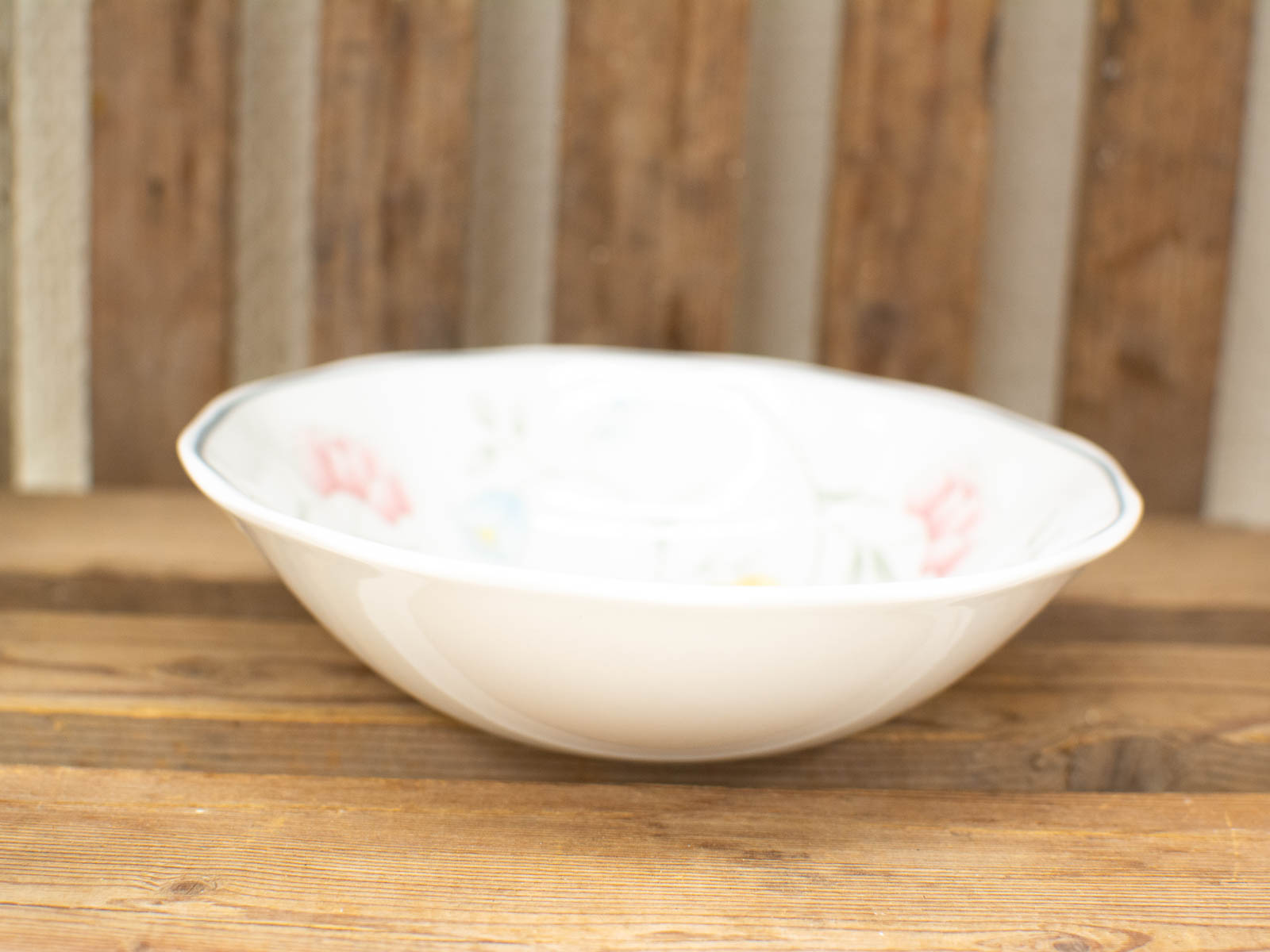 Elegant porcelain bowl with pastel floral patterns and scalloped edge, perfect for vintage decor.