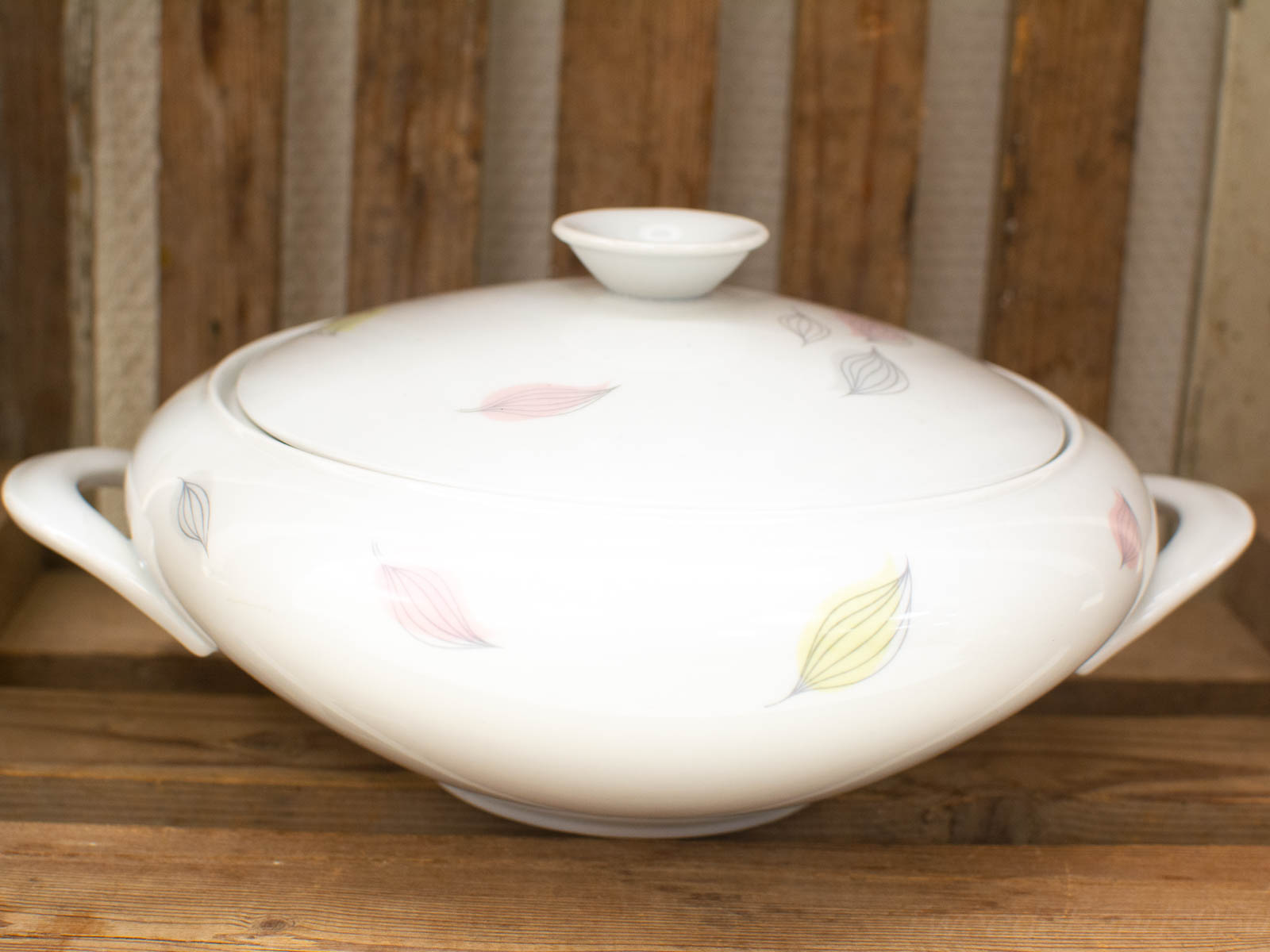 Elegant porcelain casserole with pastel leaf design, perfect for serving meals and enhancing decor.