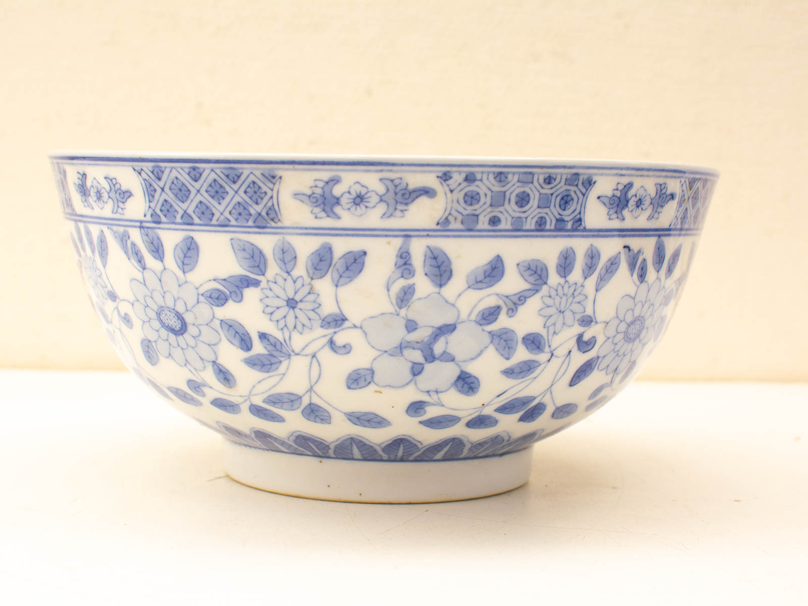 Elegant vintage porcelain bowl with intricate blue and white floral designs, perfect for display.