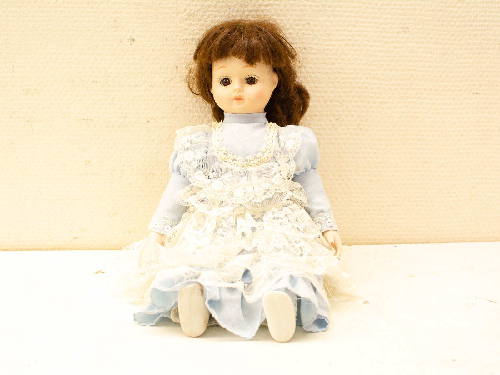 Charming vintage doll in a blue gown with lace details, perfect for collectors and nostalgia lovers.