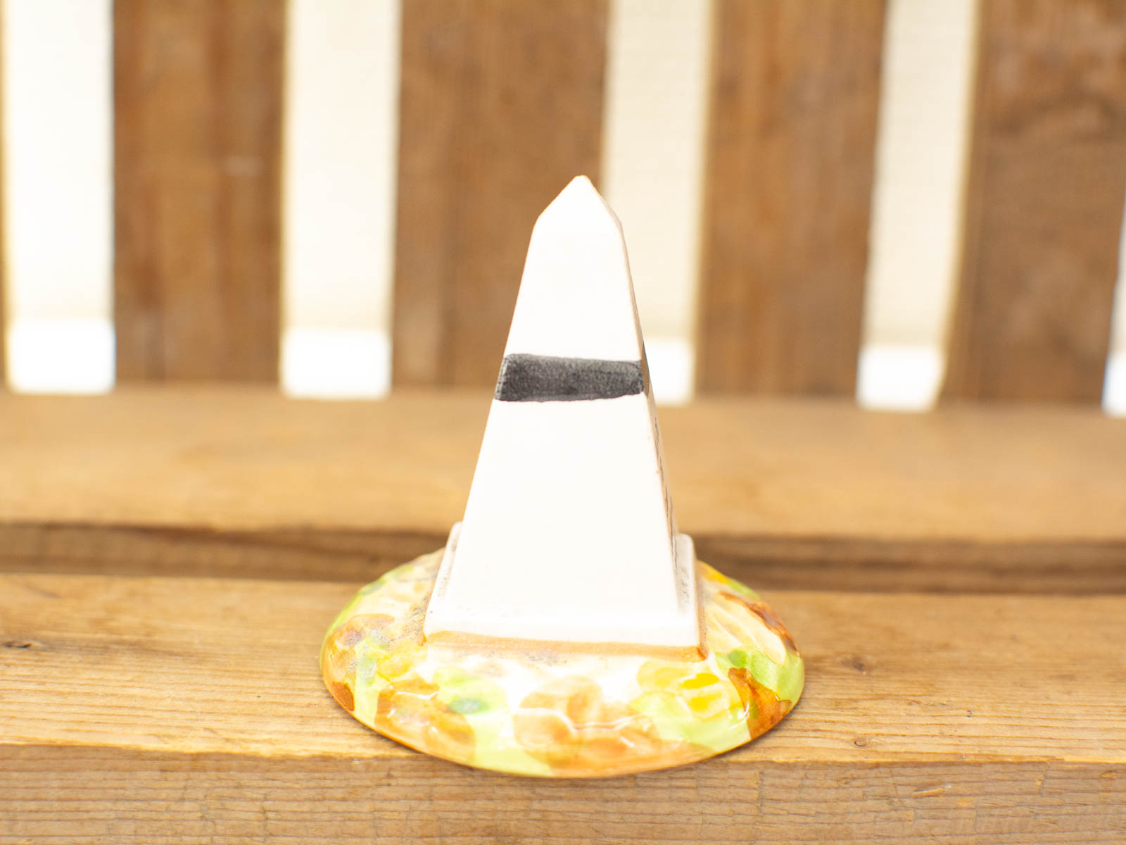 Elegant white pyramid with colorful base, perfect for enhancing your home decor.