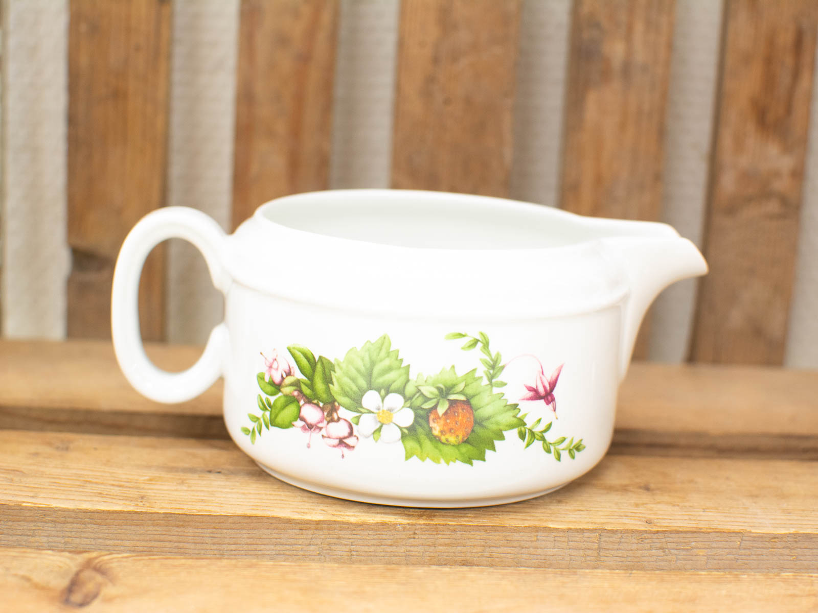 Charming porcelain creamer with botanical design, perfect for vintage-inspired tea gatherings.