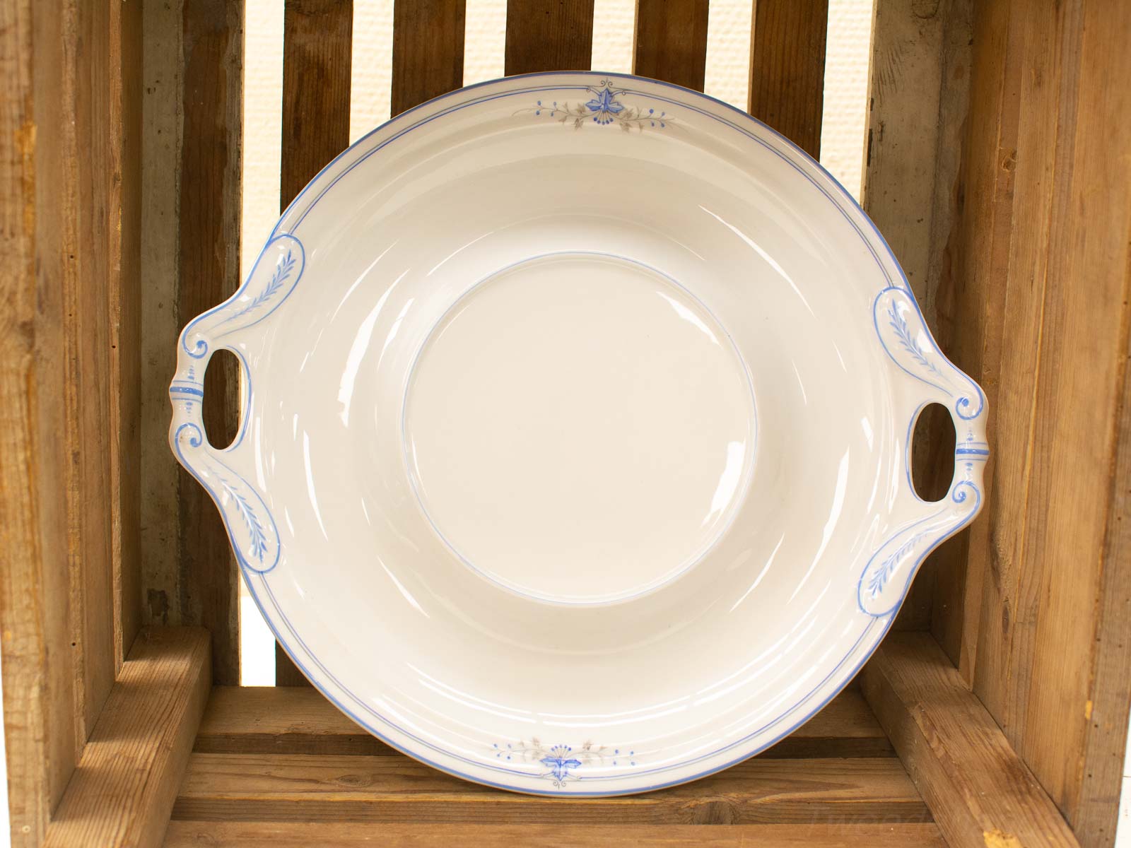 Elegant porcelain serving dish with blue accents, perfect for any dining occasion.