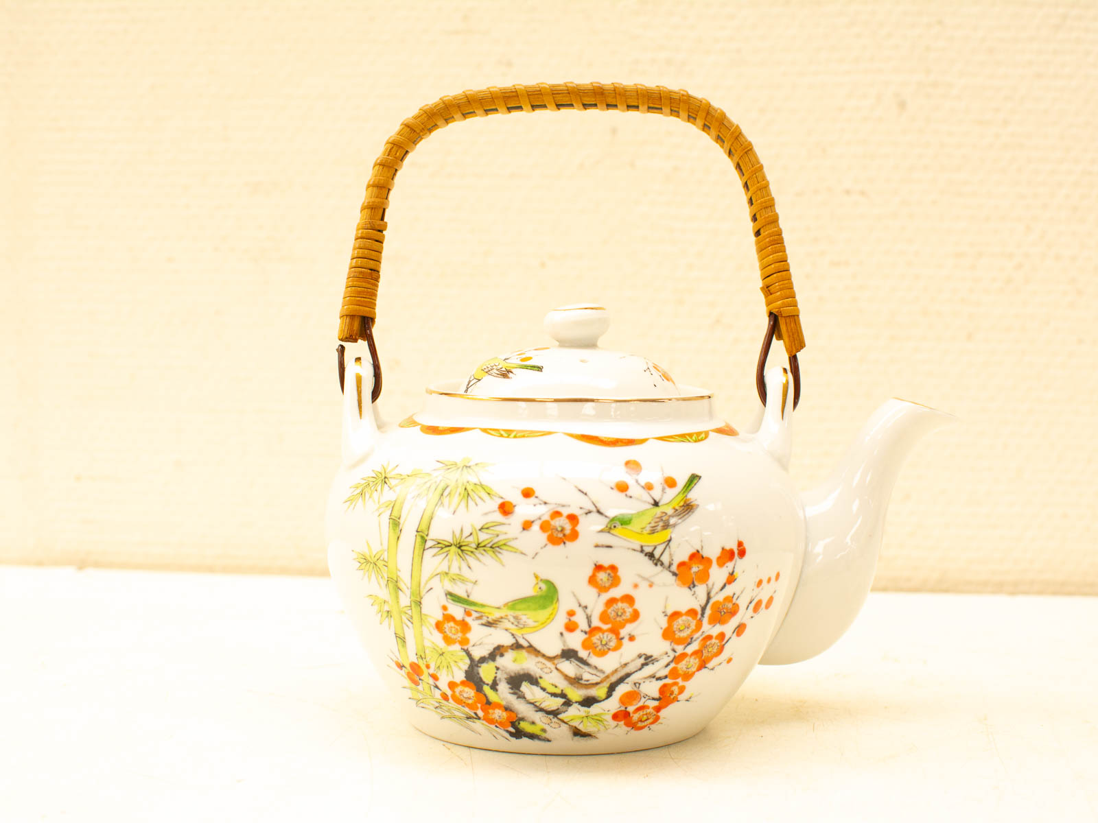 Elegant porcelain teapot with vibrant nature motifs, perfect for tea lovers and collectors.