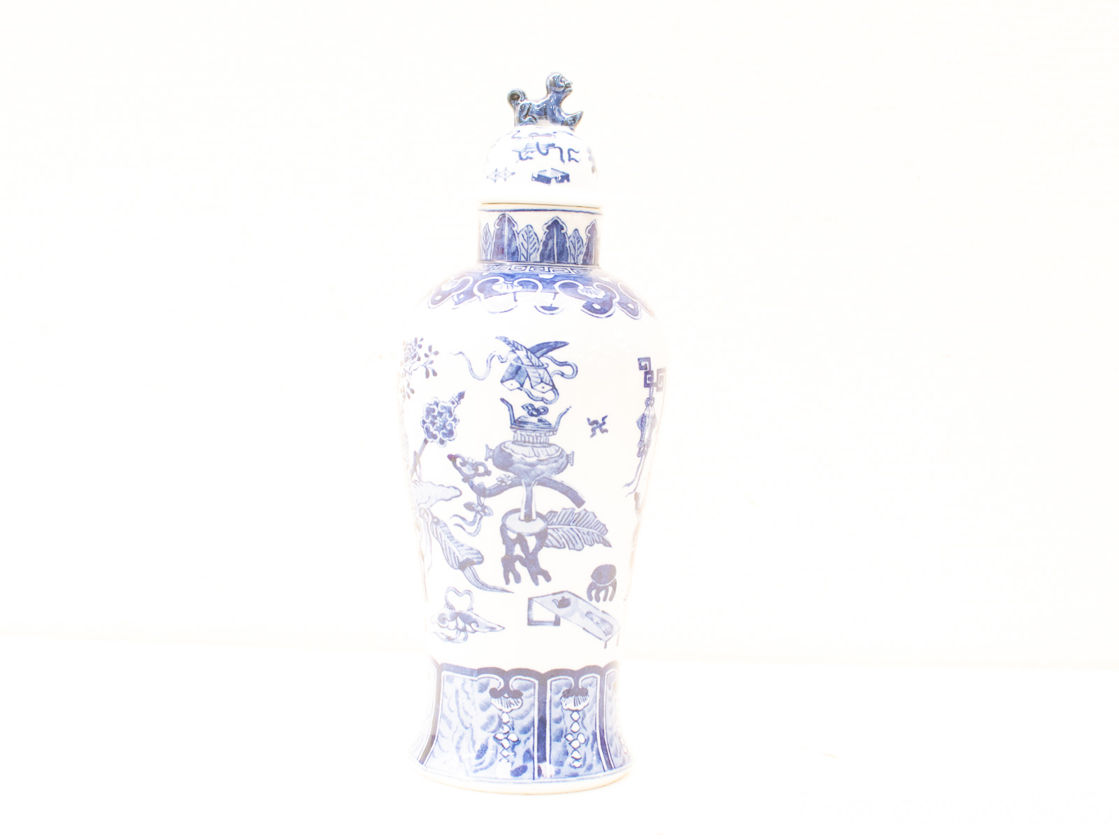 Elegant blue-and-white porcelain vase with intricate designs and a matching lid, showcasing Asian artistry.