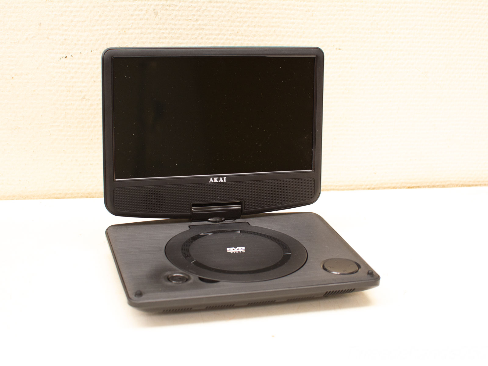 Sleek matte black AKAI portable DVD player, perfect for on-the-go entertainment and travel.