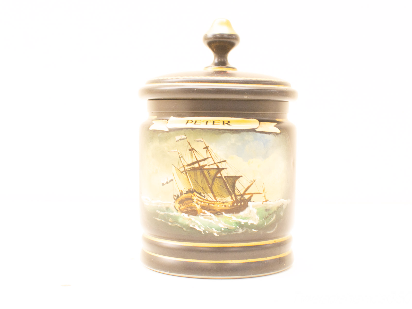 Elegant decorative jar with sailing ship design and gold accents for nautical-themed decor.