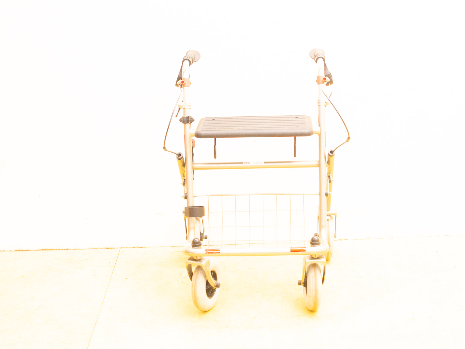 Lightweight vintage mobility walker with wheels, ergonomic handles, and convenient storage basket for comfort.