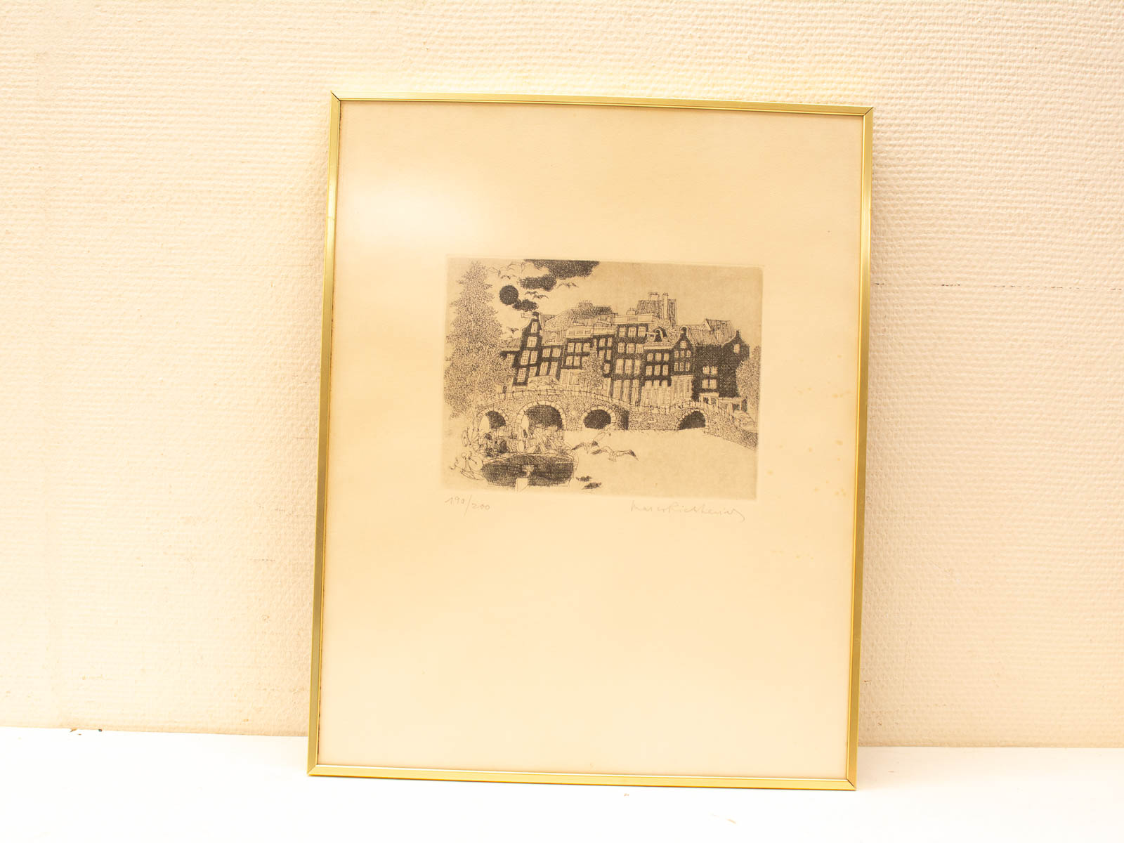 Monochromatic European architecture print in gold frame, limited edition 179/200, adds historic charm.