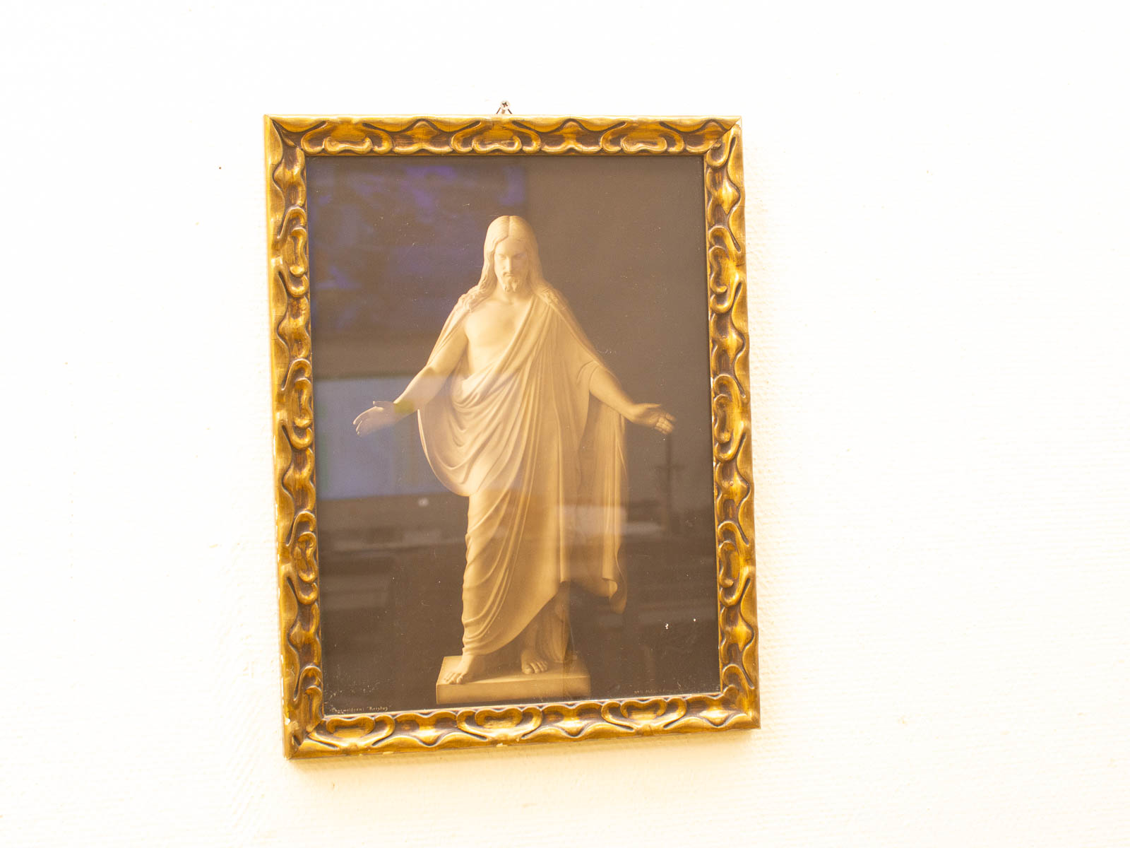 Serene religious figure in ornate gold frame, inviting peace and reflection in any space.