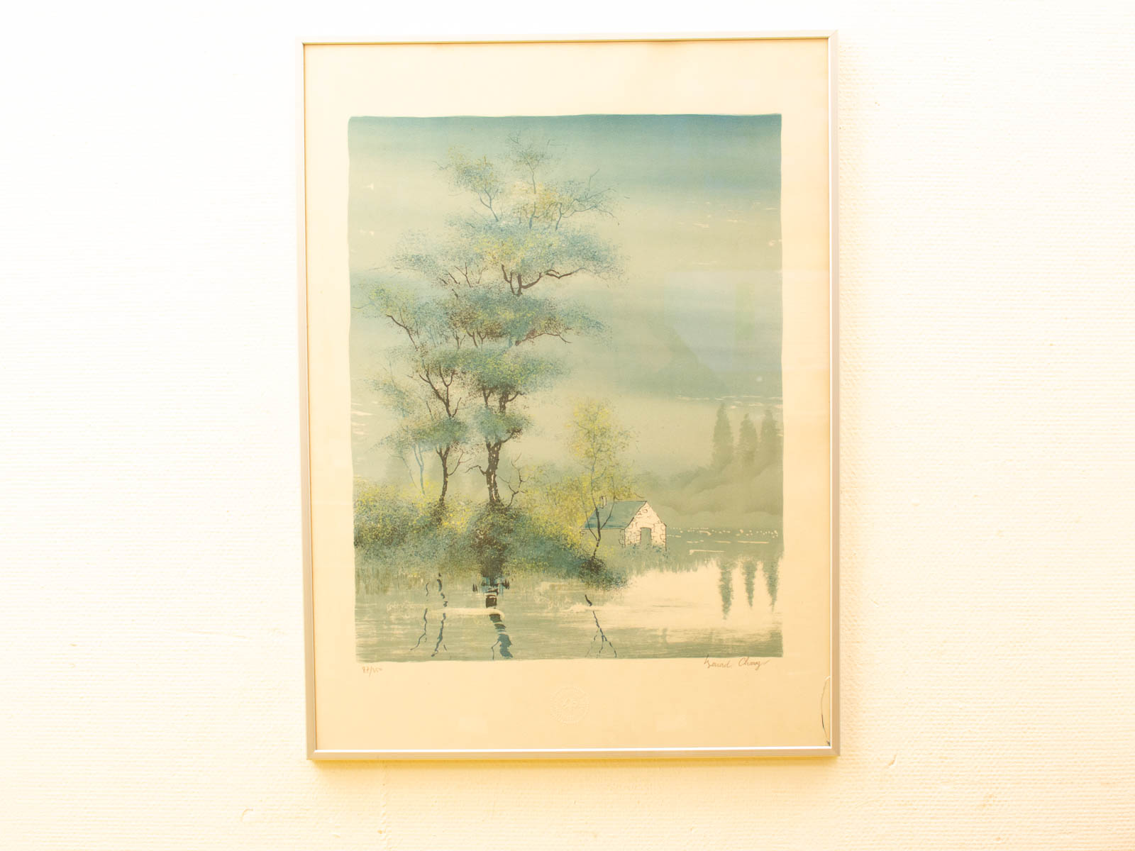 Tranquil watercolor landscape with a cottage and tree, evoking serene natural beauty.