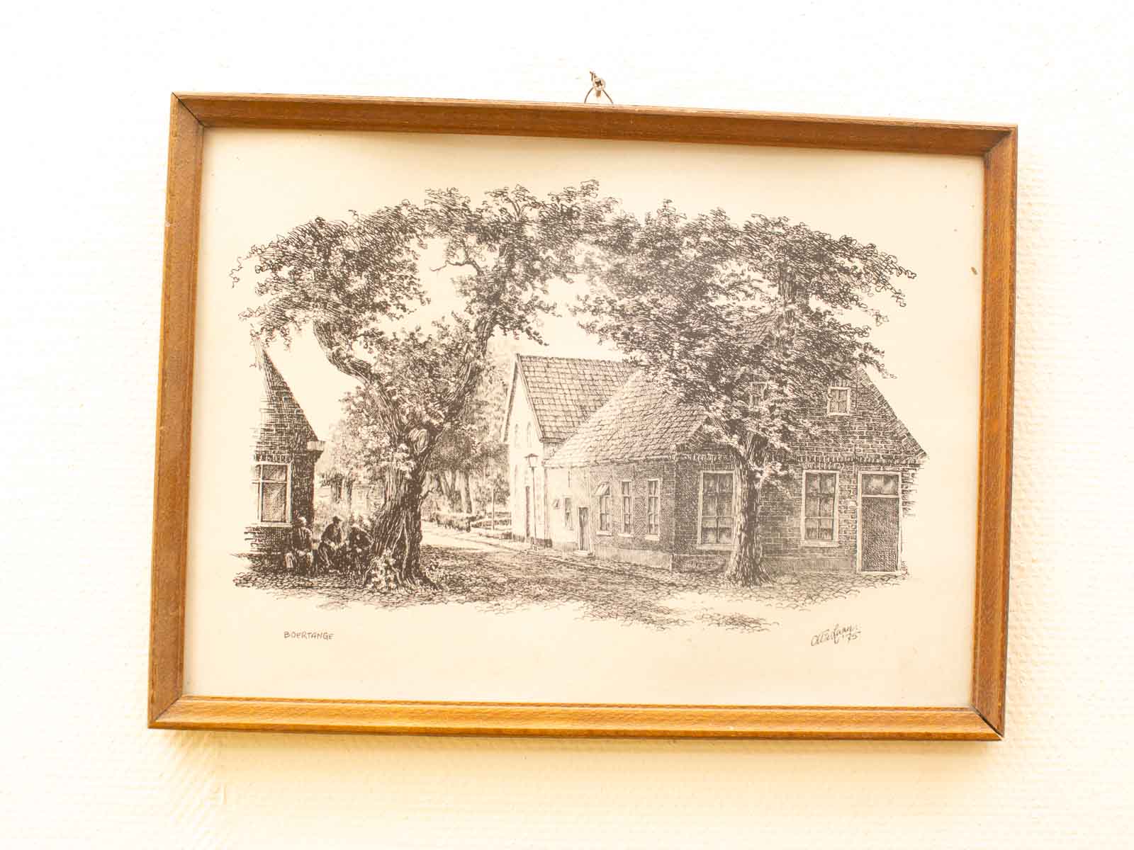 Vintage black-and-white drawing of tranquil countryside homes framed by a gnarled tree.