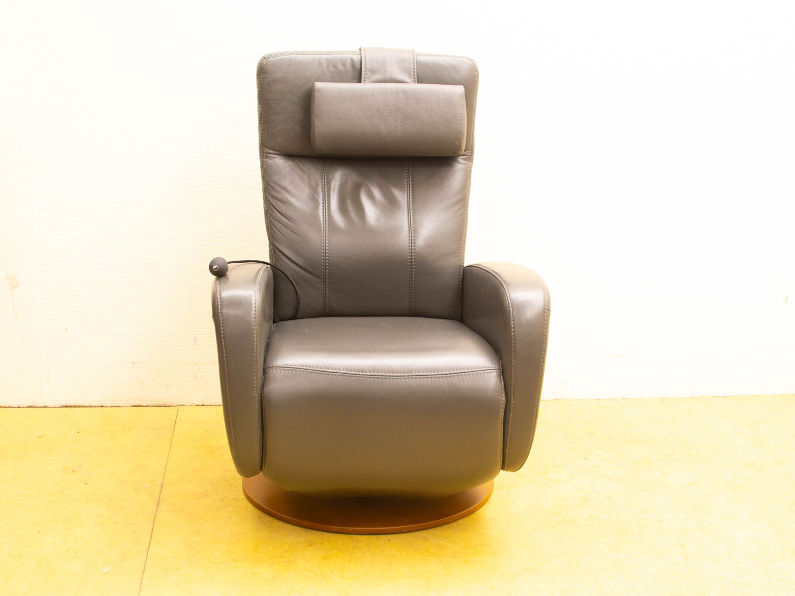 Modern gray recliner chair with leather upholstery and swivel base for ultimate comfort.