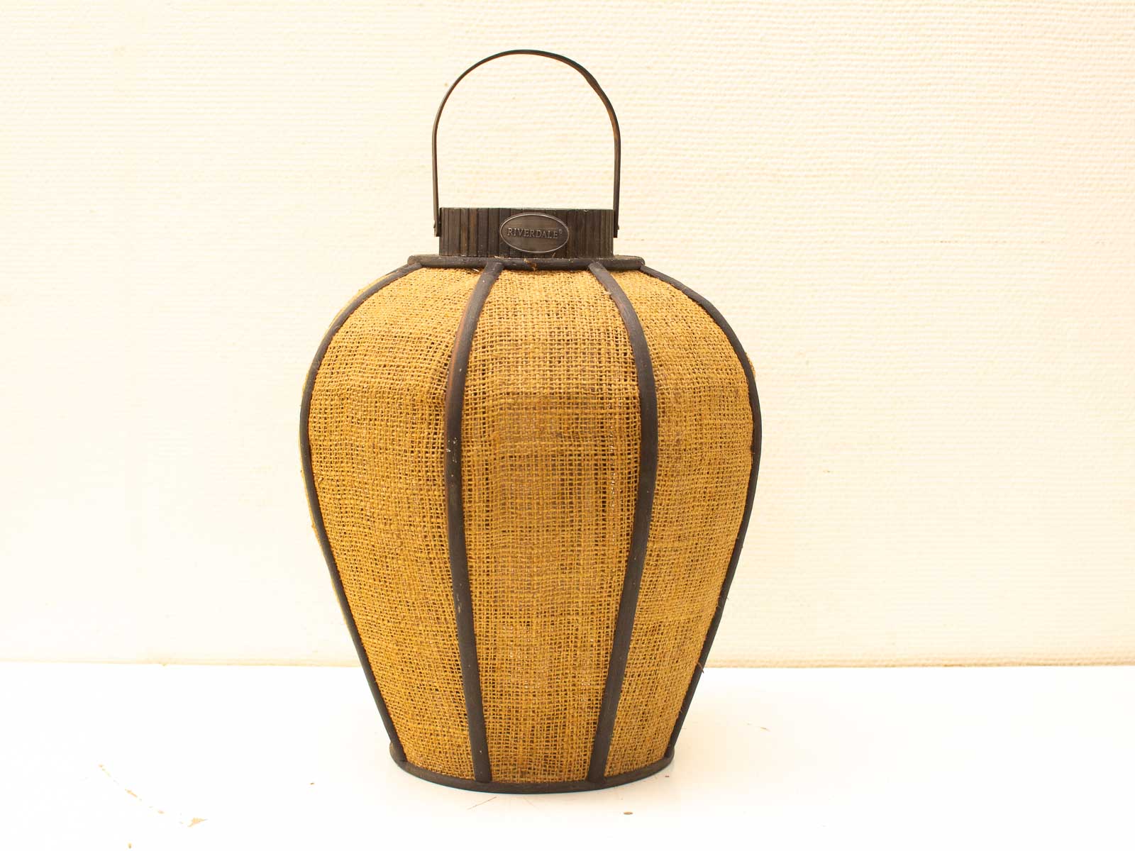 Woven lantern with metal accents, perfect for adding warmth and charm to any space.