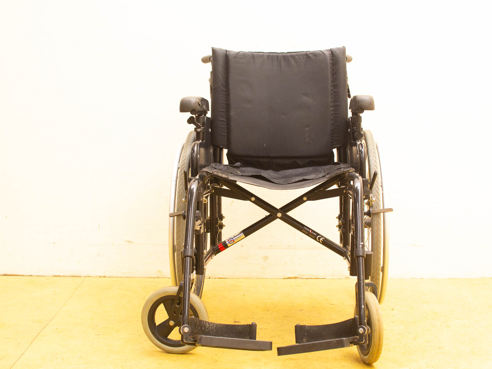 Stylish black wheelchair with padded comfort, sturdy frame, and easy-to-maneuver large wheels.