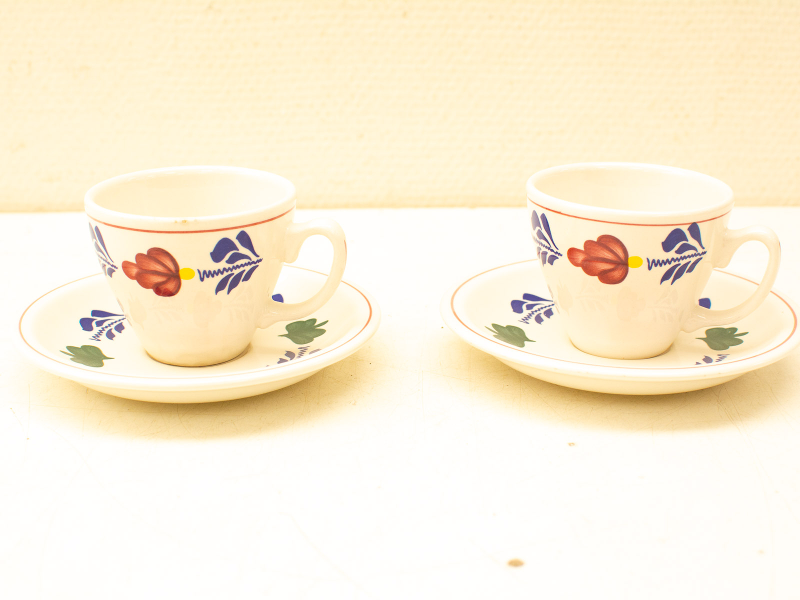 Delicate porcelain coffee cups with vibrant floral designs for elegant tea time gatherings.