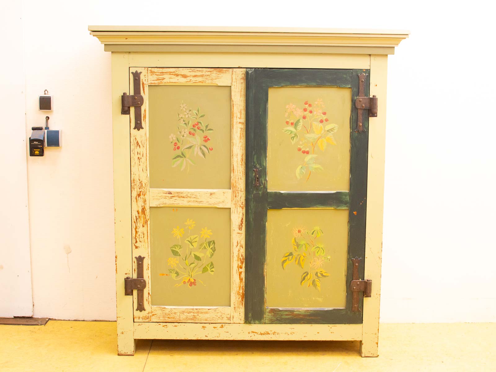 Charming vintage wooden cabinet with floral glass panels, perfect for cozy decor enthusiasts.