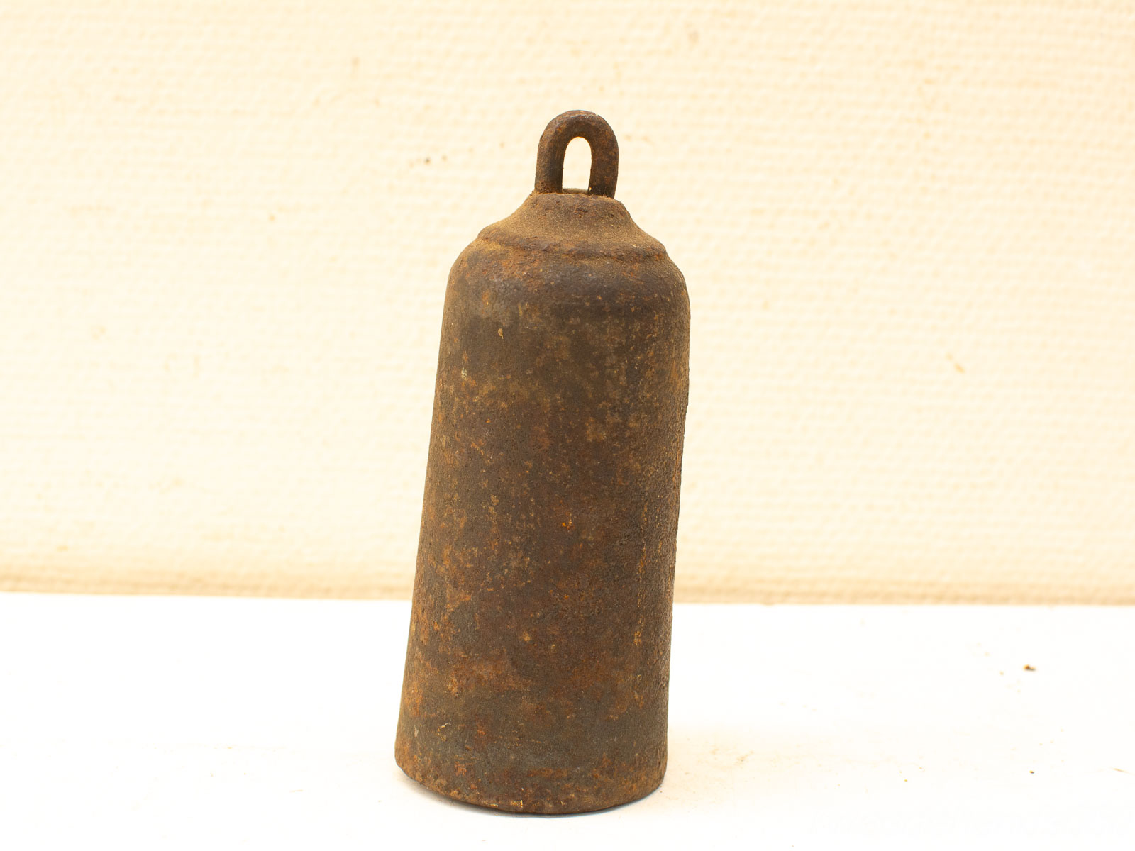 Antique rusty metal bell with rustic charm, perfect for vintage decor and timeless elegance.