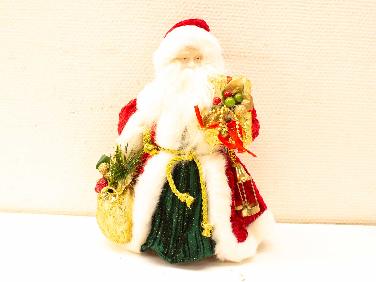 Charming vintage Santa Claus decoration with gifts, perfect for festive holiday decor.