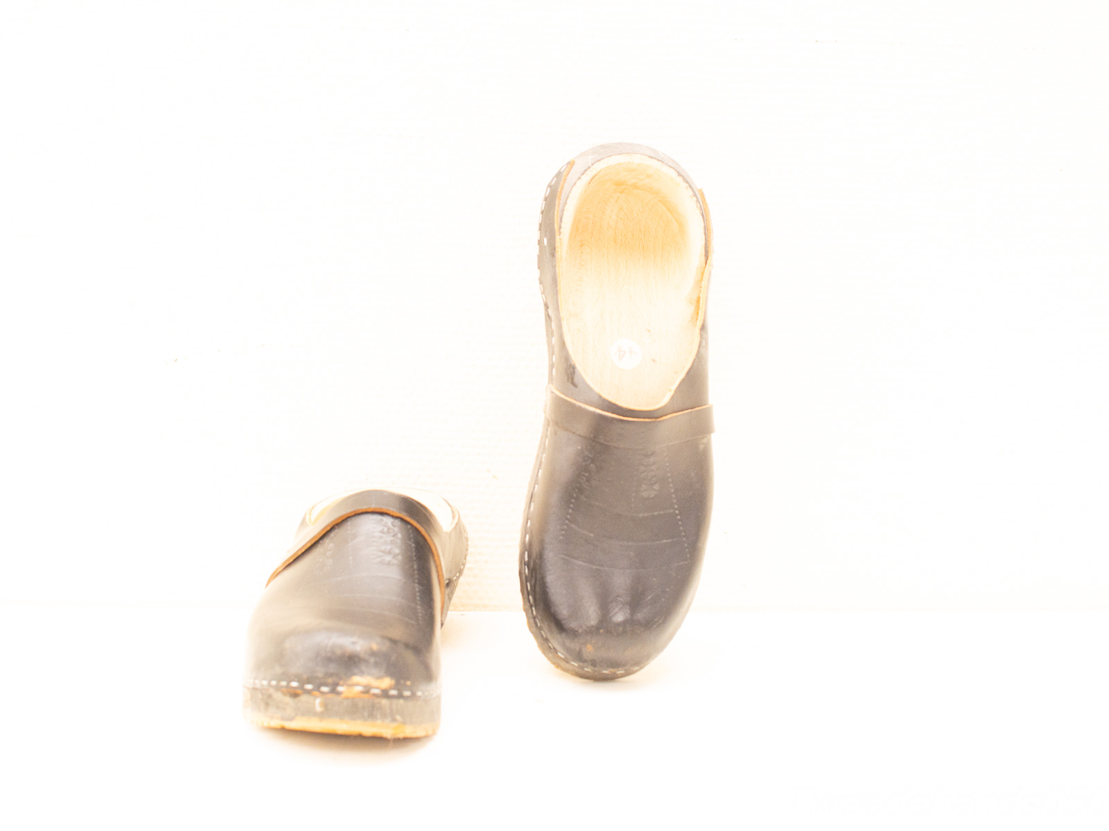 Traditional Dutch wooden clogs with leather straps, perfect for comfort and style in any setting.