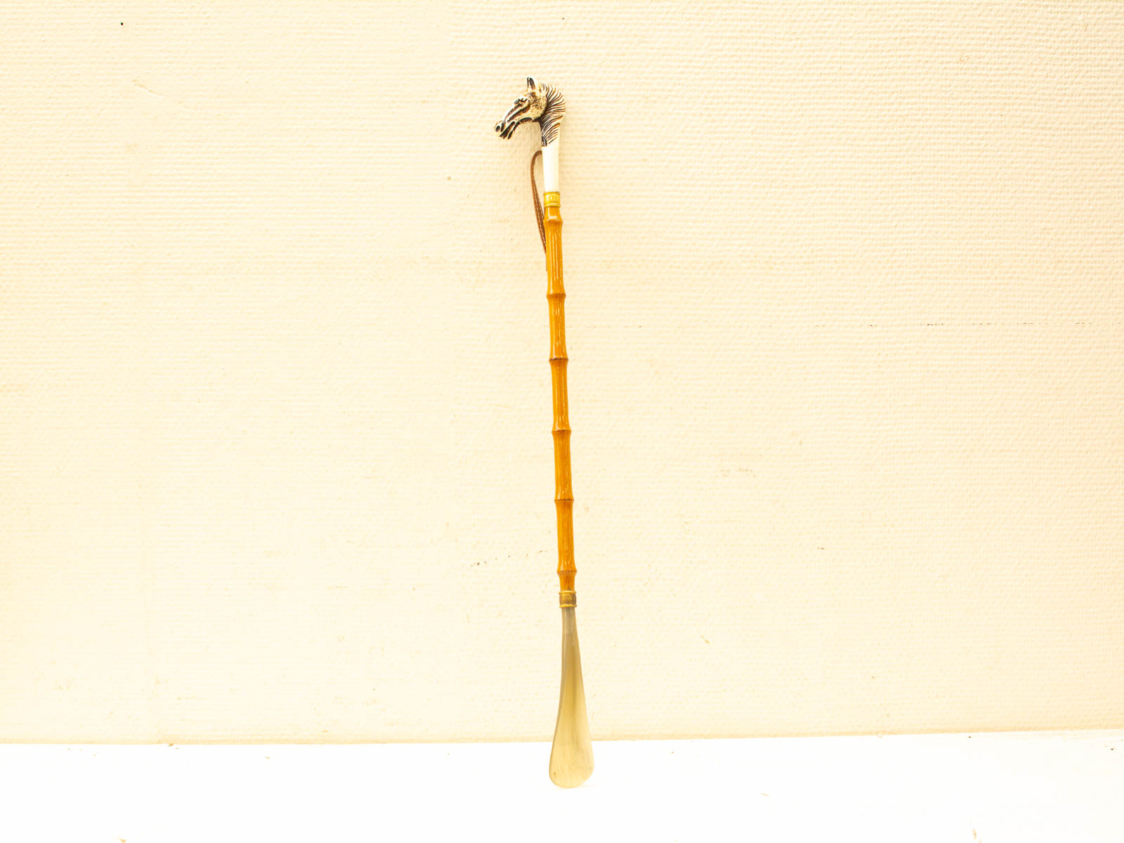 Elegant bamboo serving utensil with a striking silver horse head finial. Perfect for special occasions.