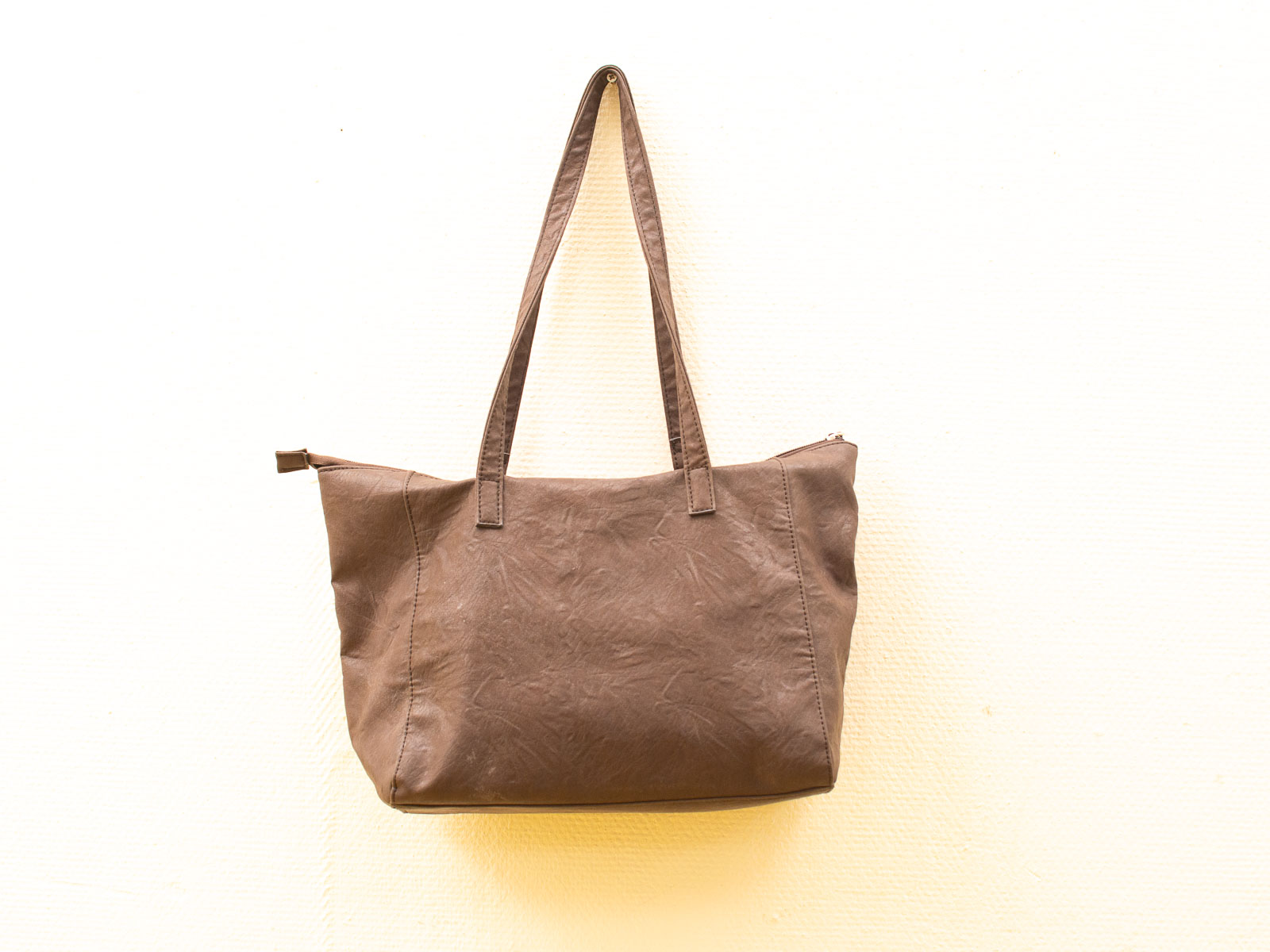 Stylish brown tote bag with zipper, perfect for daily use and versatile outfits.