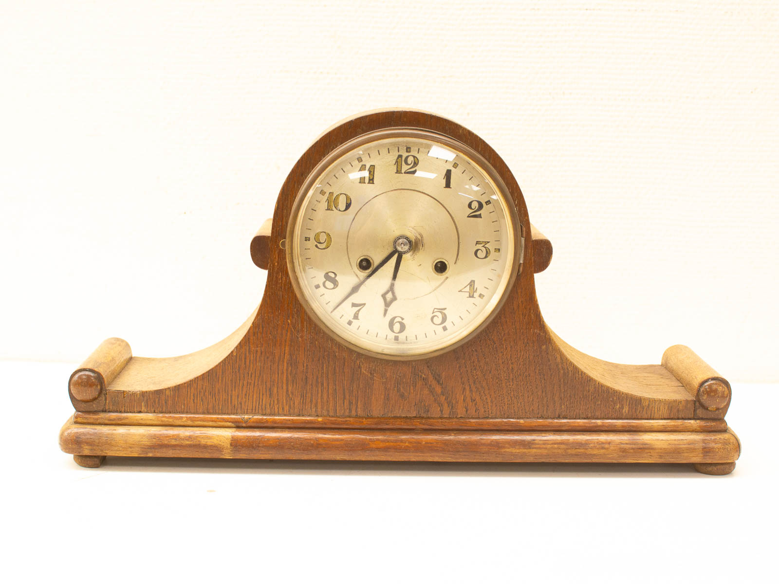 Elegant vintage wooden mantel clock with brass accents for classic home decor.