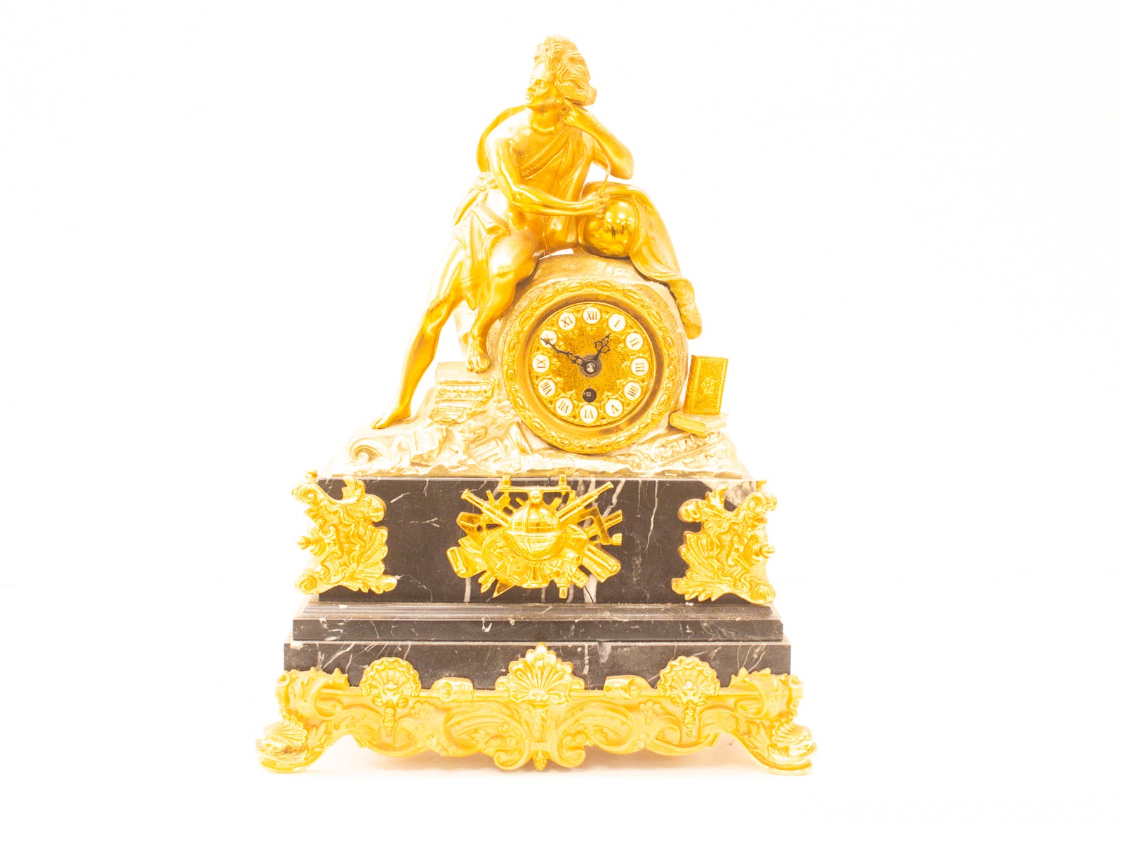 Elegant neoclassical gilded mantel clock on polished black marble, blending art and functionality.