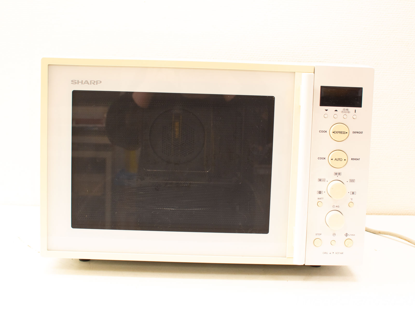 Sleek off-white SHARP microwave with digital display, user-friendly controls, perfect for any kitchen.