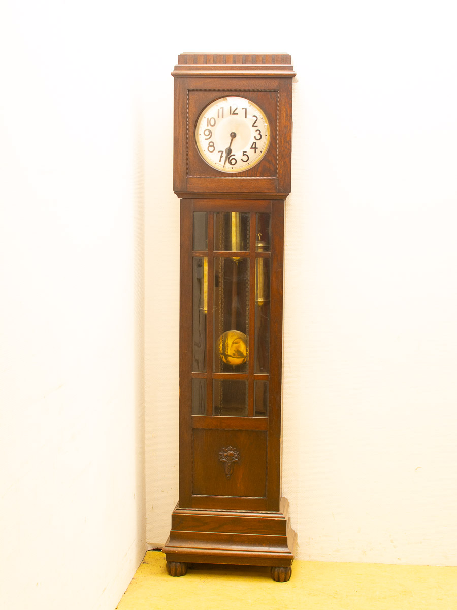 Elegant vintage wooden grandfather clock with brass pendulum, perfect for classic decor.