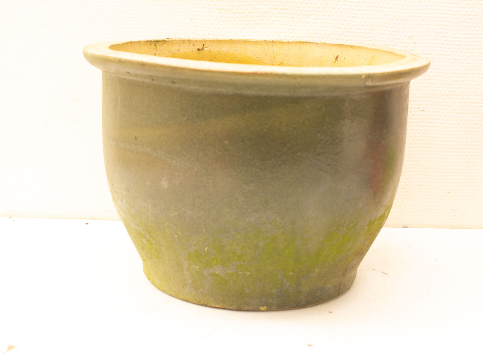 Vintage rounded ceramic pot in earthy green and gray tones, perfect for indoor or outdoor plants.