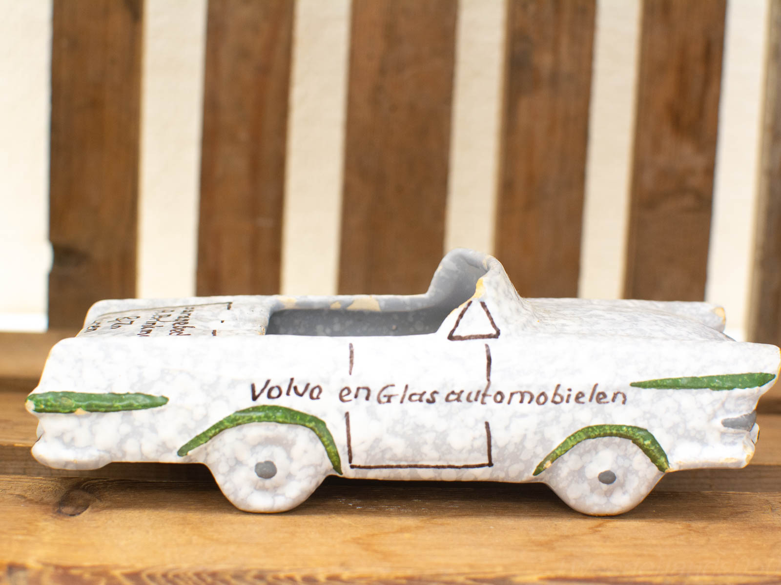 Vintage ceramic convertible car with green accents, celebrating automotive heritage for collectors and enthusiasts.