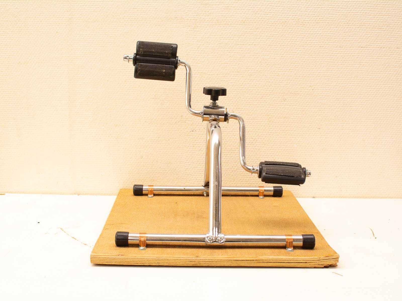 Stylish chrome stand with wooden base and padded rollers for instruments and equipment support.