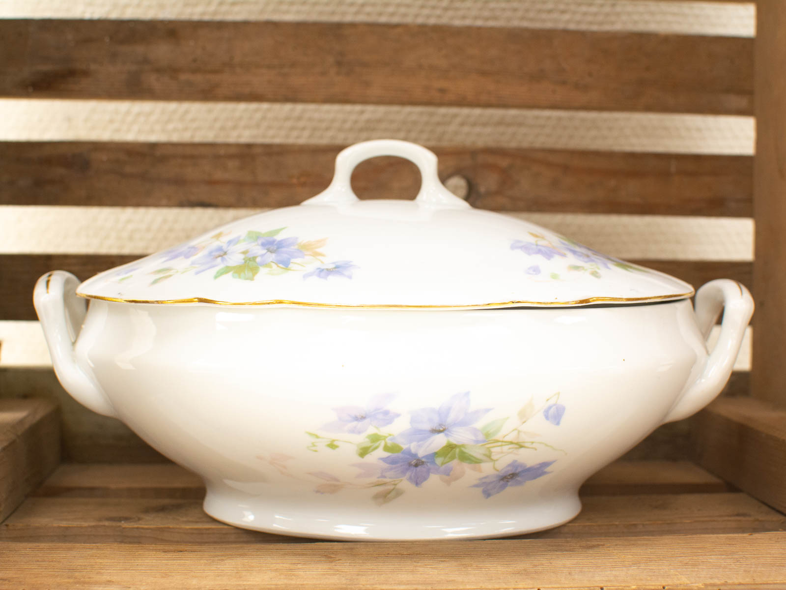 Elegant vintage porcelain tureen with floral designs and gold rim, perfect for special occasions.