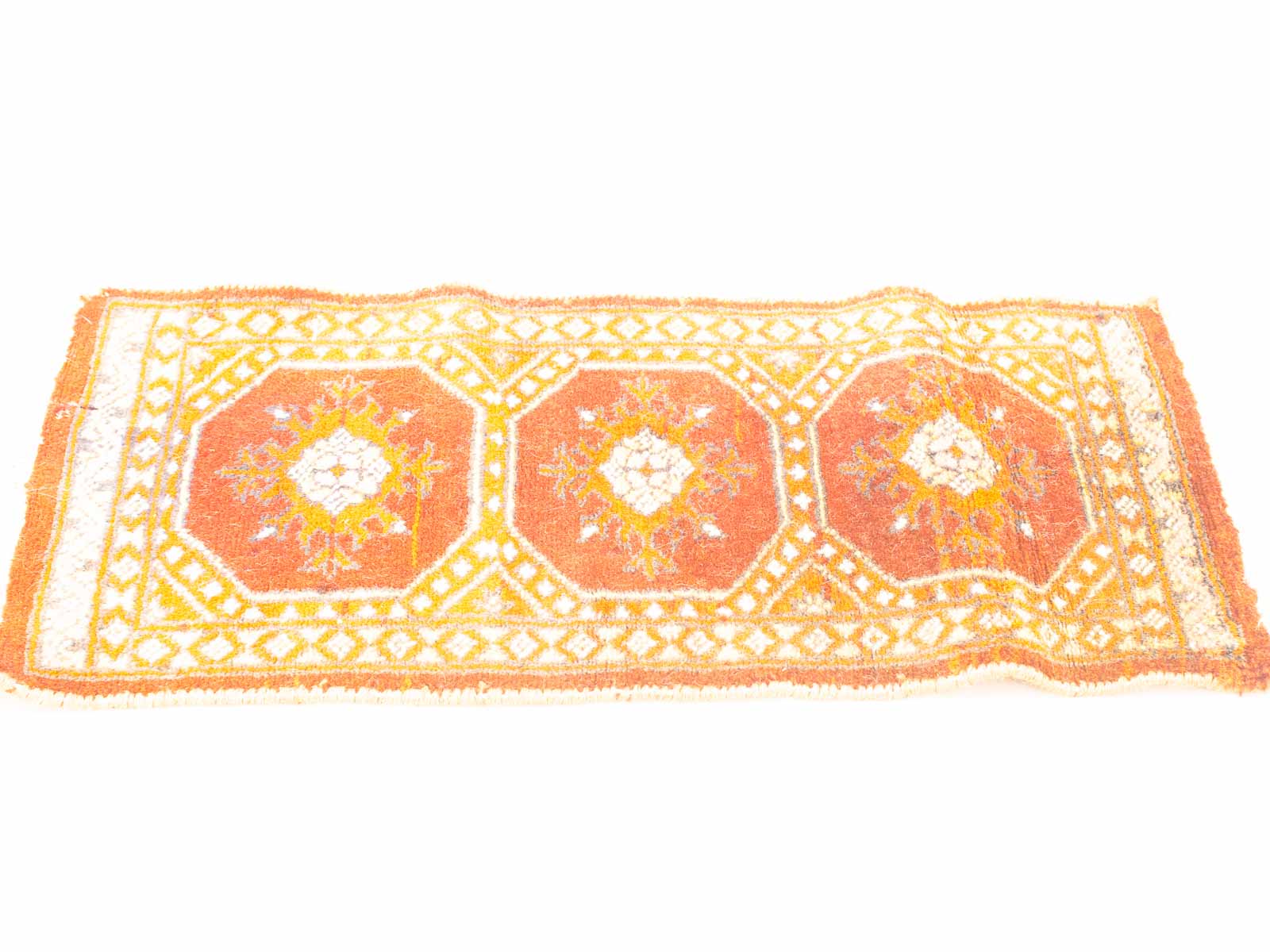 Vibrant orange vintage rug with floral designs, adding charm to any space. Handcrafted elegance.