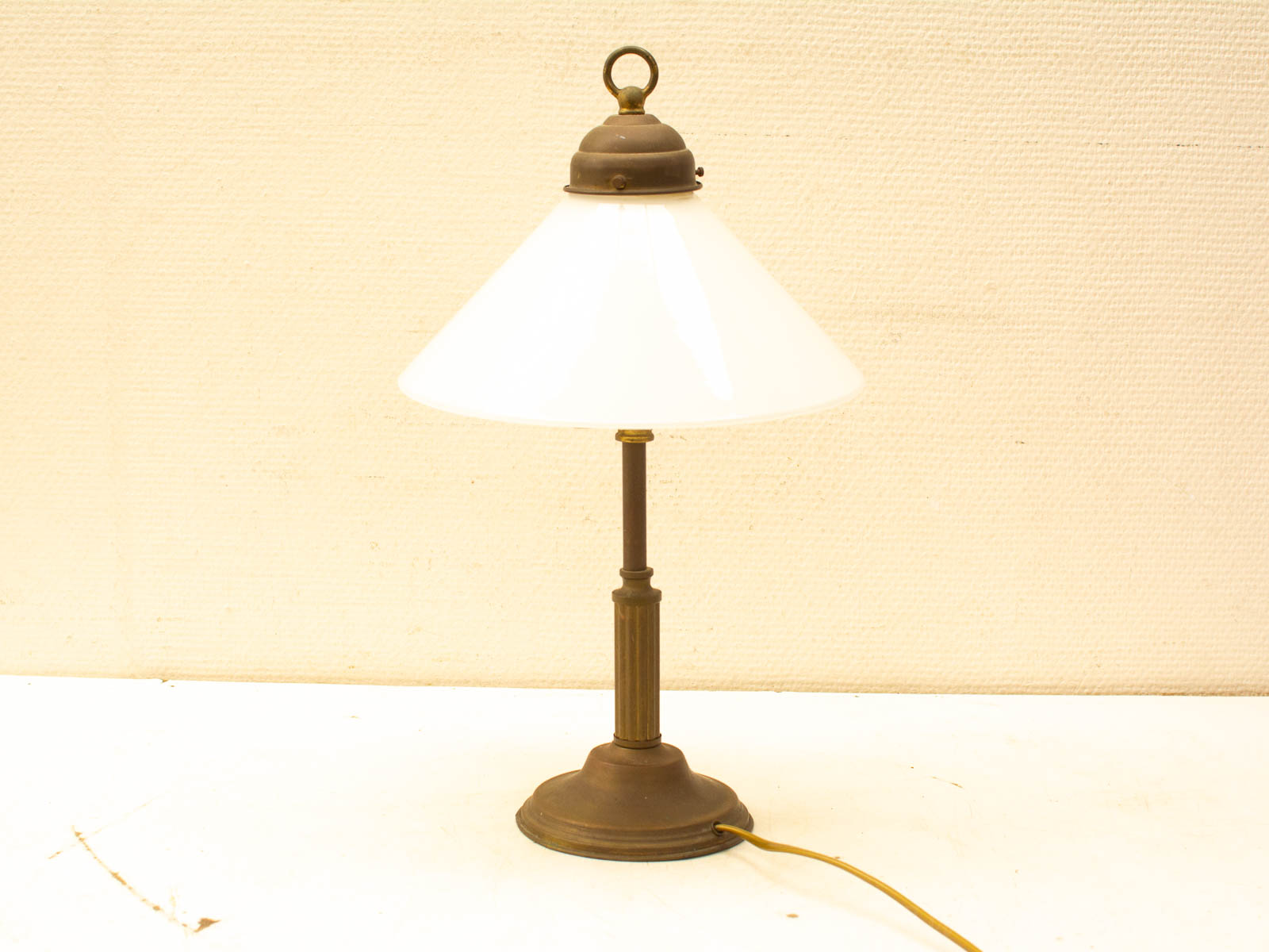 Elegant vintage table lamp with dark base and white conical shade, perfect for cozy spaces.