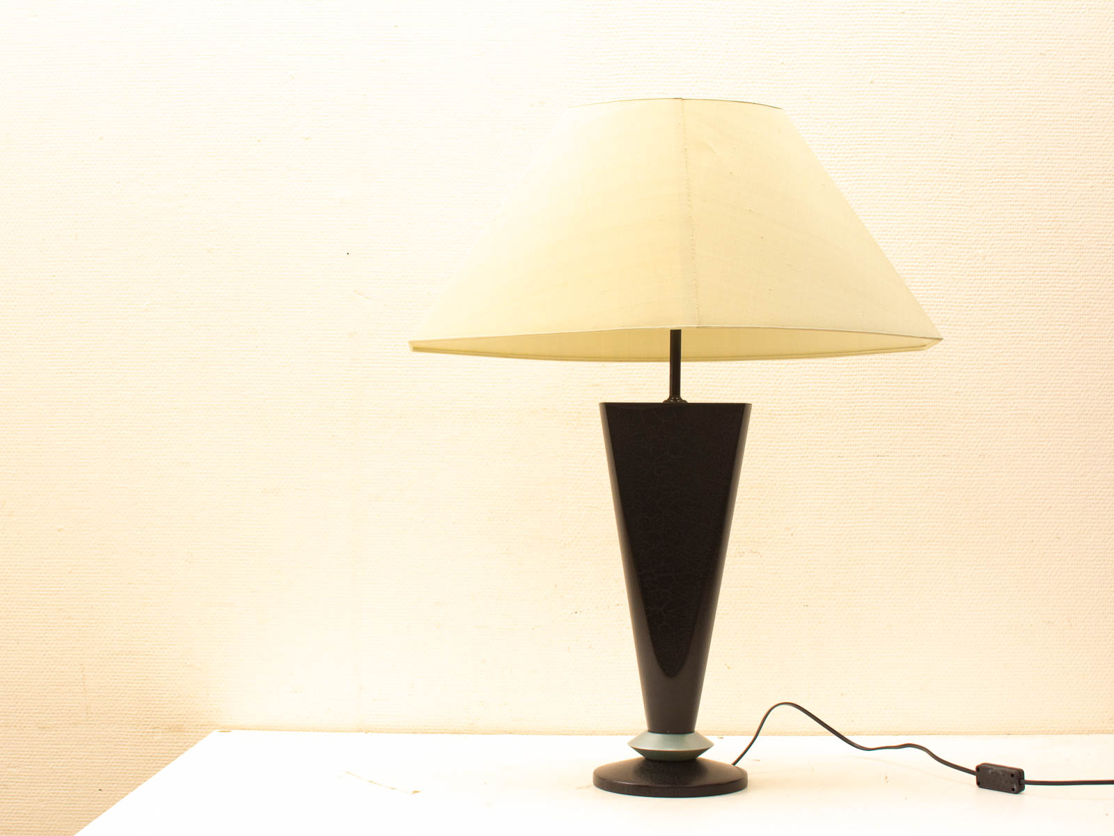 Stylish vintage table lamp with black conical base and turquoise accent, ideal for modern decor.