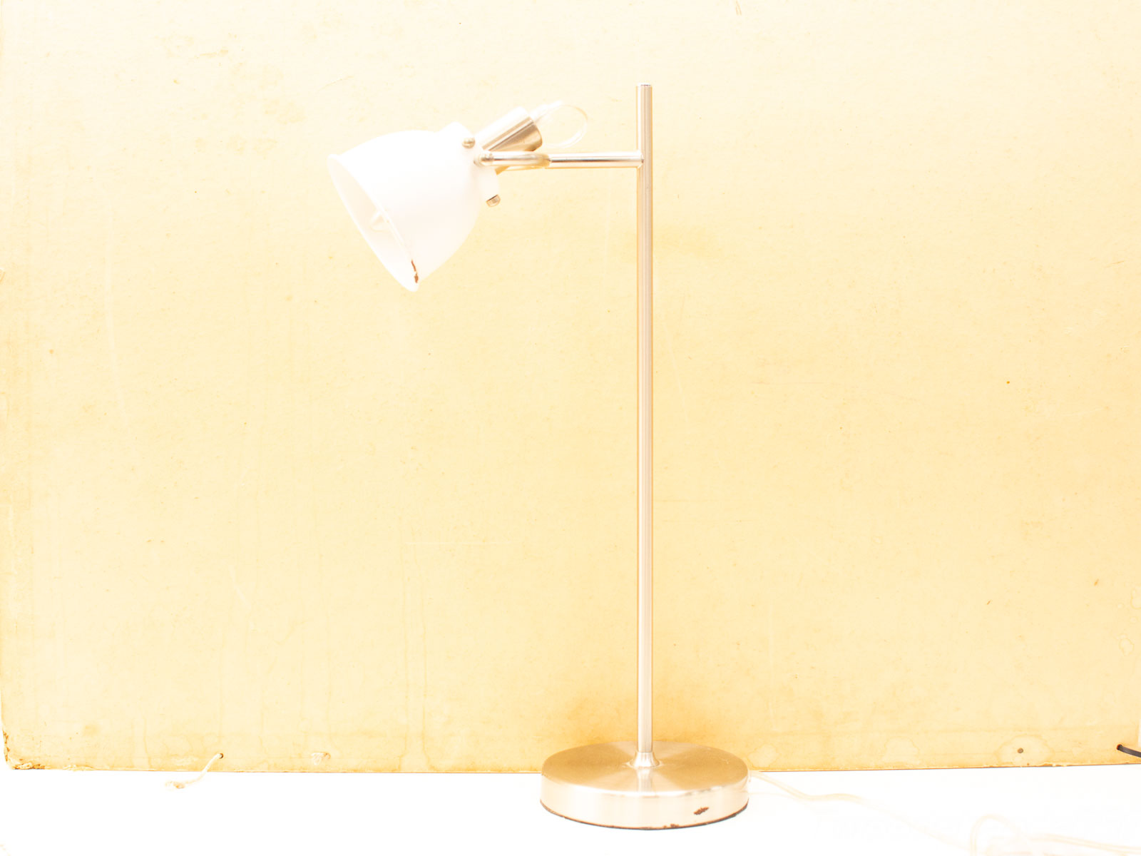 Sleek chrome desk lamp with a white conical shade, perfect for modern workspaces and reading.