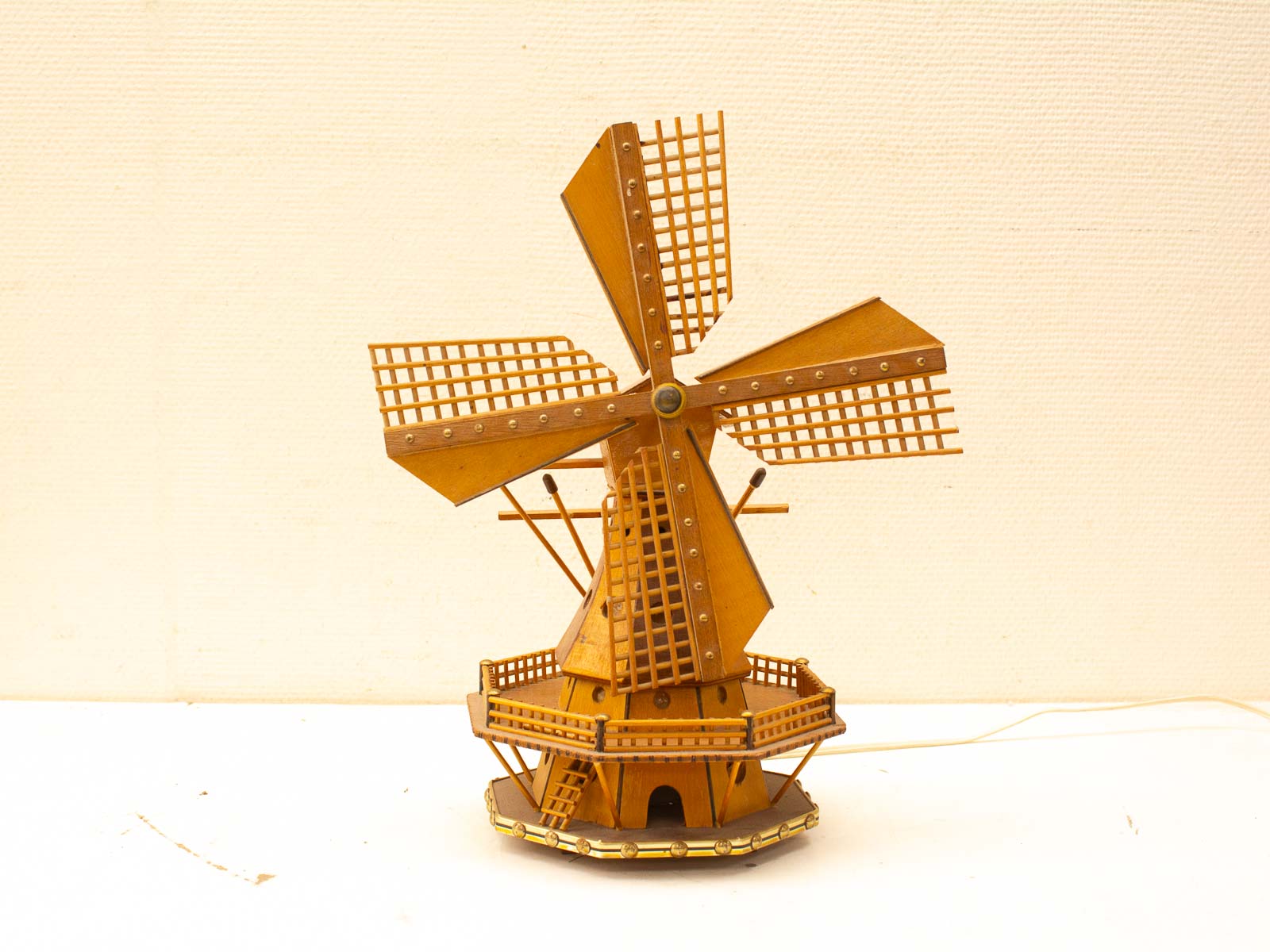 Charming wooden windmill model, perfect vintage decor with intricate details and rustic appeal.