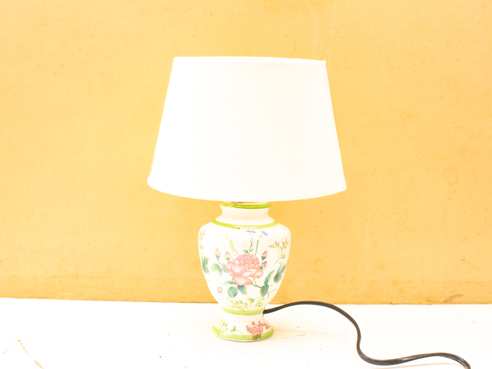 Elegant vintage table lamp with floral design, perfect for adding charm to any decor.