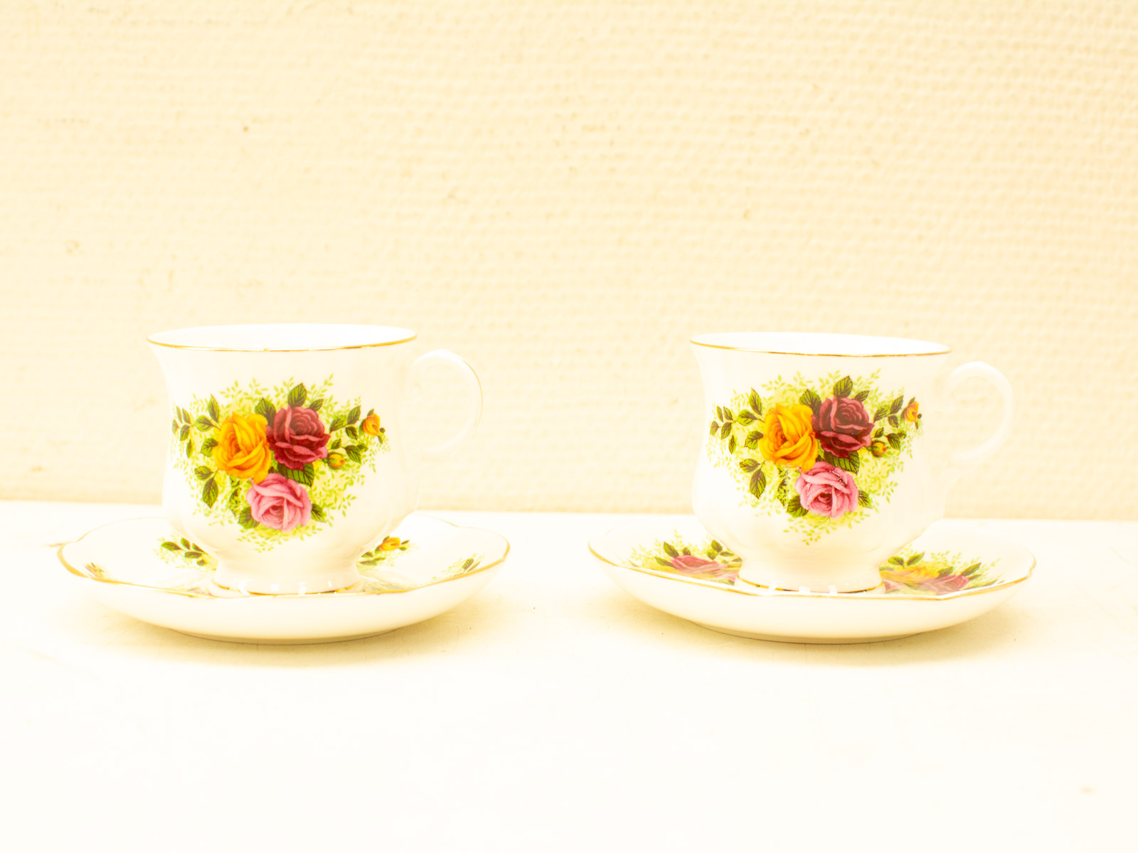 Charming vintage teacup set with rose designs, perfect for elegant tea parties and refined moments.