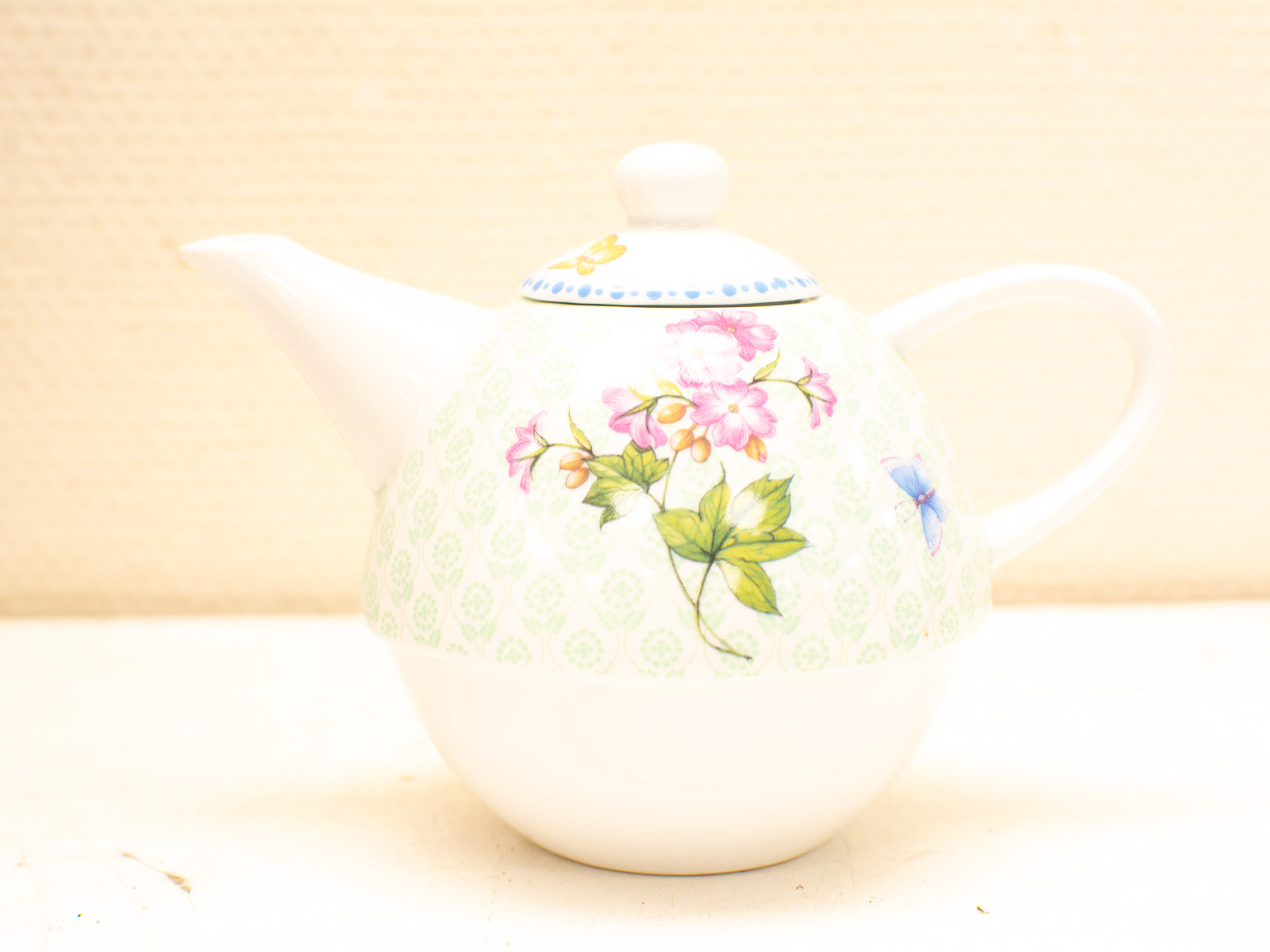 Elegant porcelain teapot with floral design, perfect for tea lovers and stylish table settings.