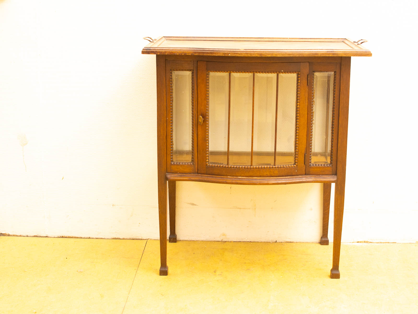 Charming vintage wooden cabinet with glass door, perfect for storage and decor in any space.